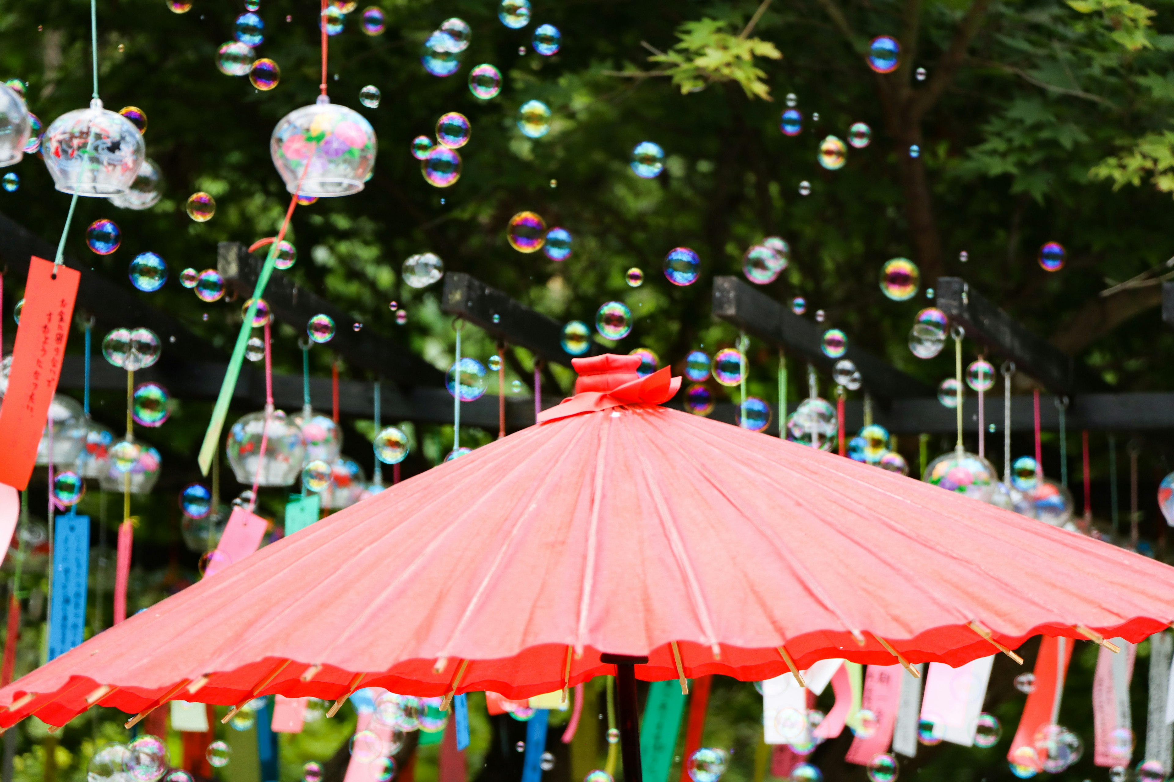 Colorful scene with a red umbrella and floating bubbles