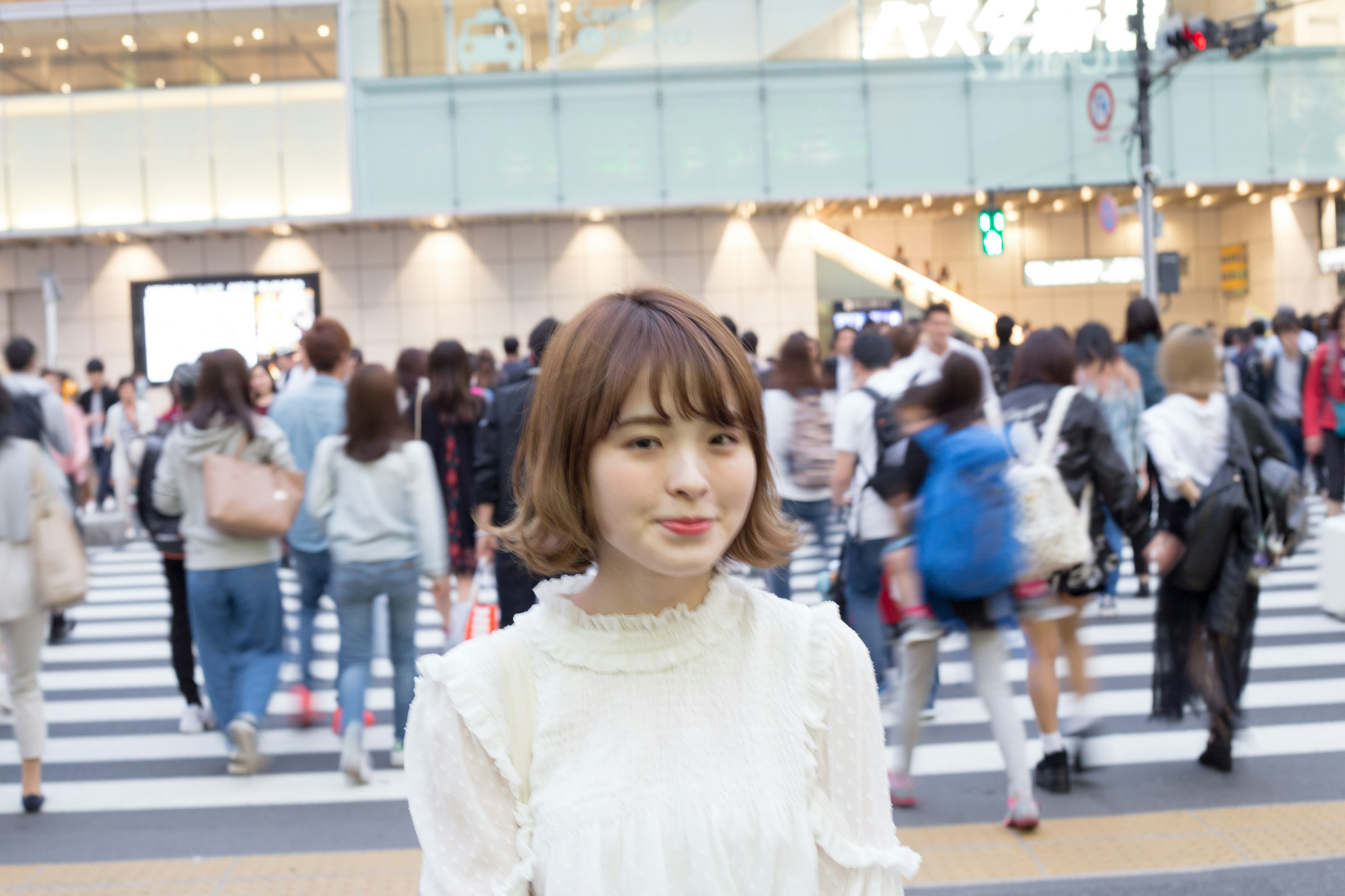 Portrait of a woman standing in front of a crosswalk