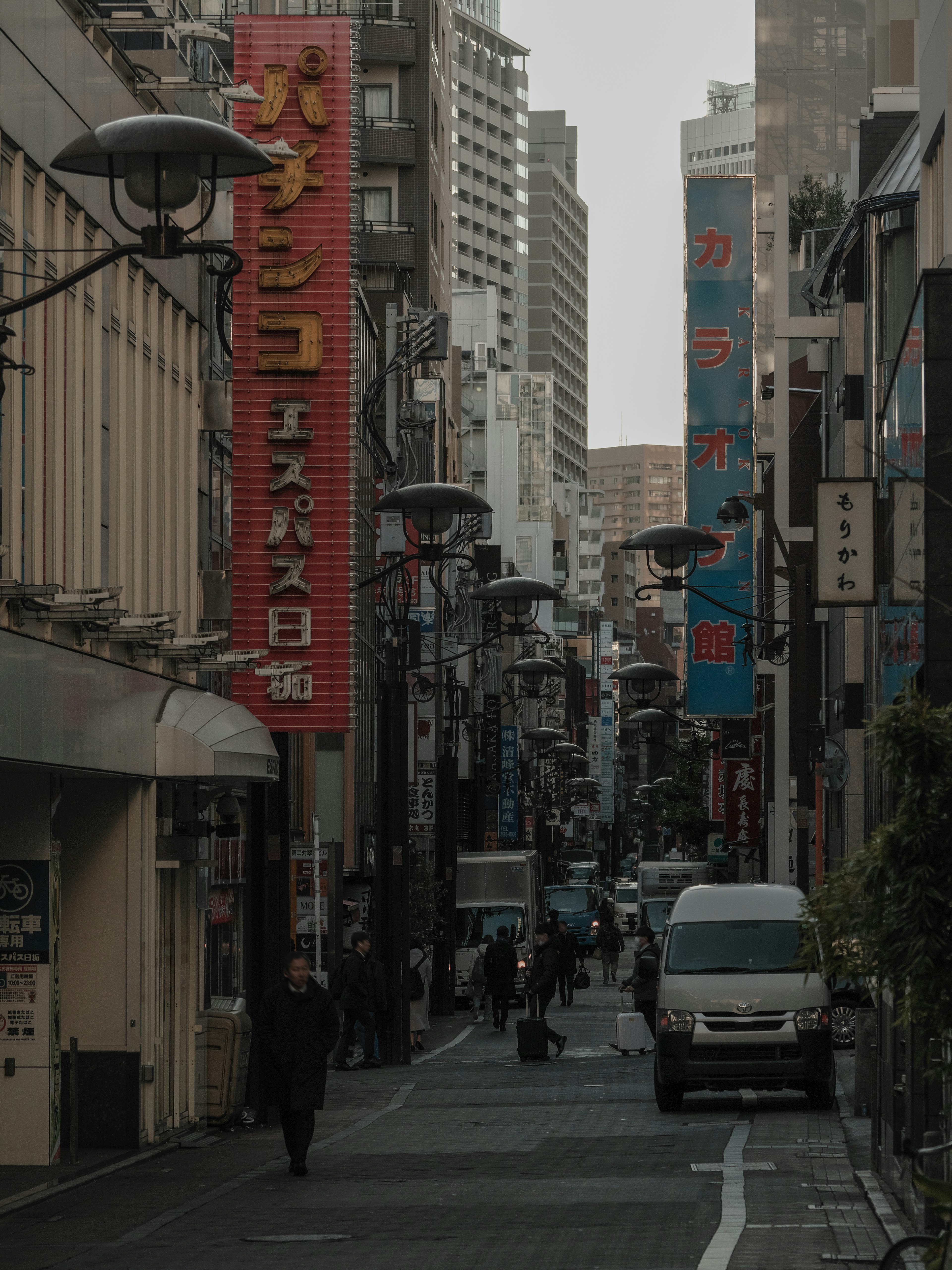 Narrow street lined with buildings and colorful signs