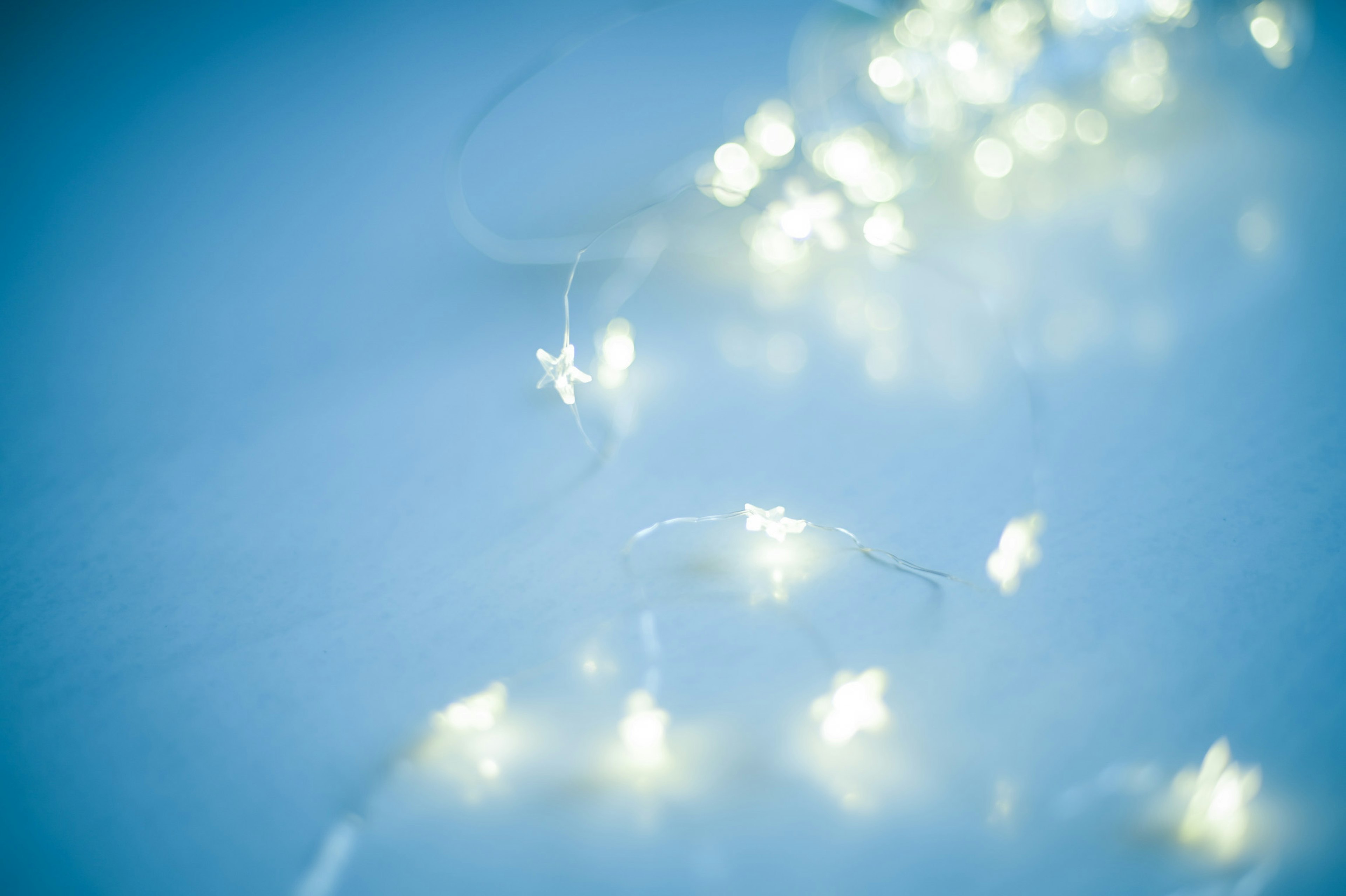 Softly glowing white LED lights on a blue background