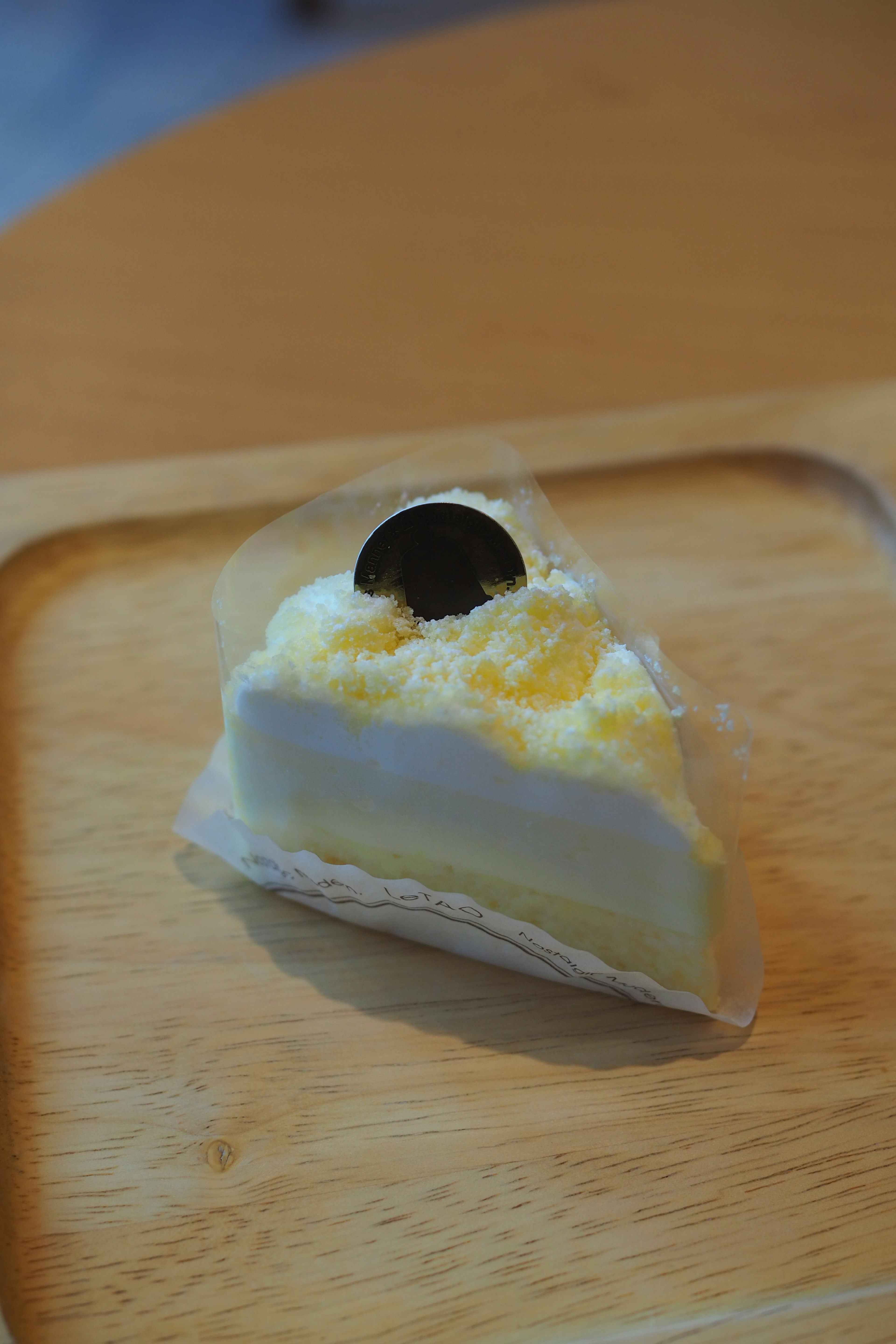 A slice of cake with yellow cream and a chocolate topping