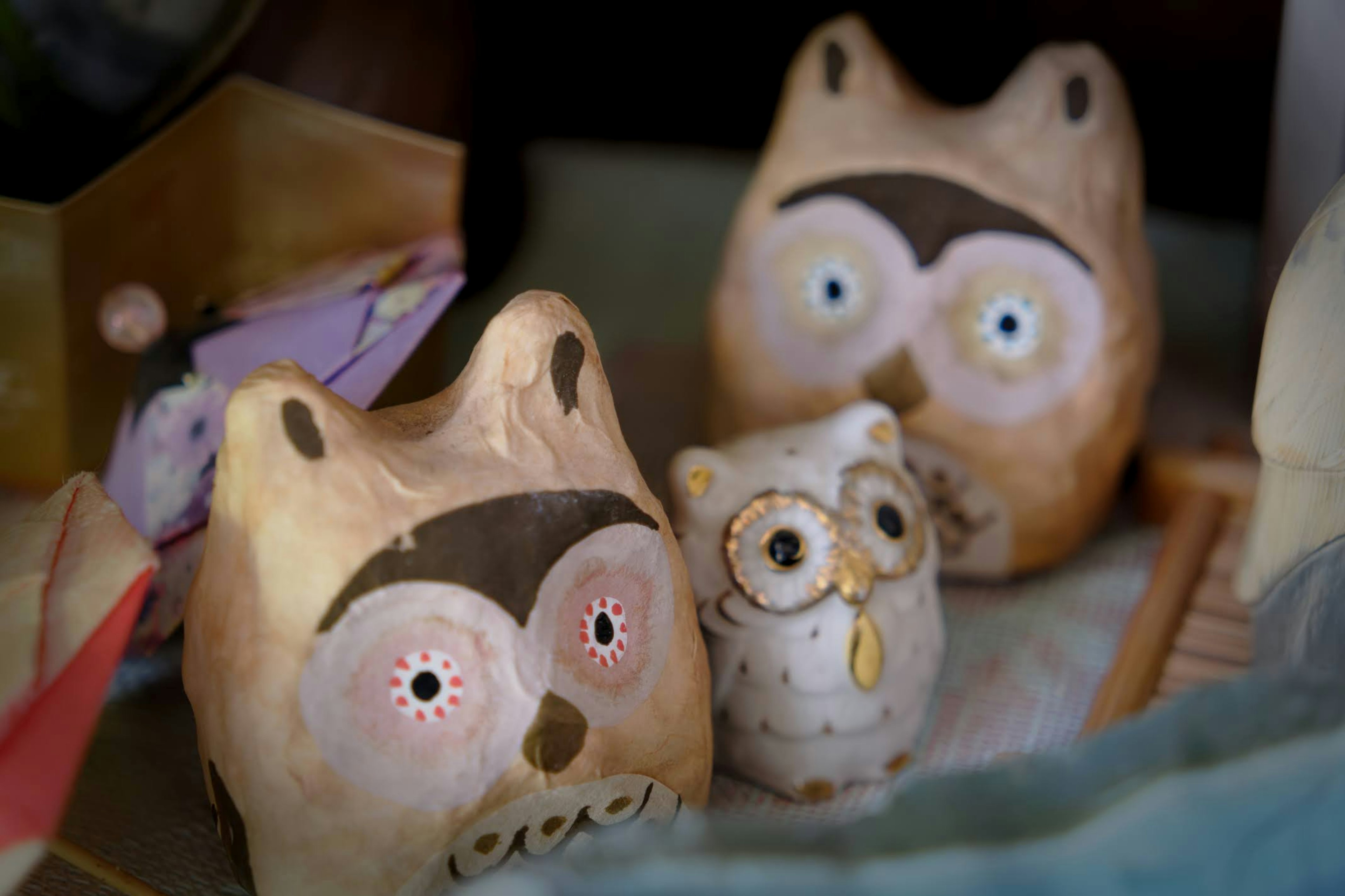 Ceramic owl figurines arranged in a display