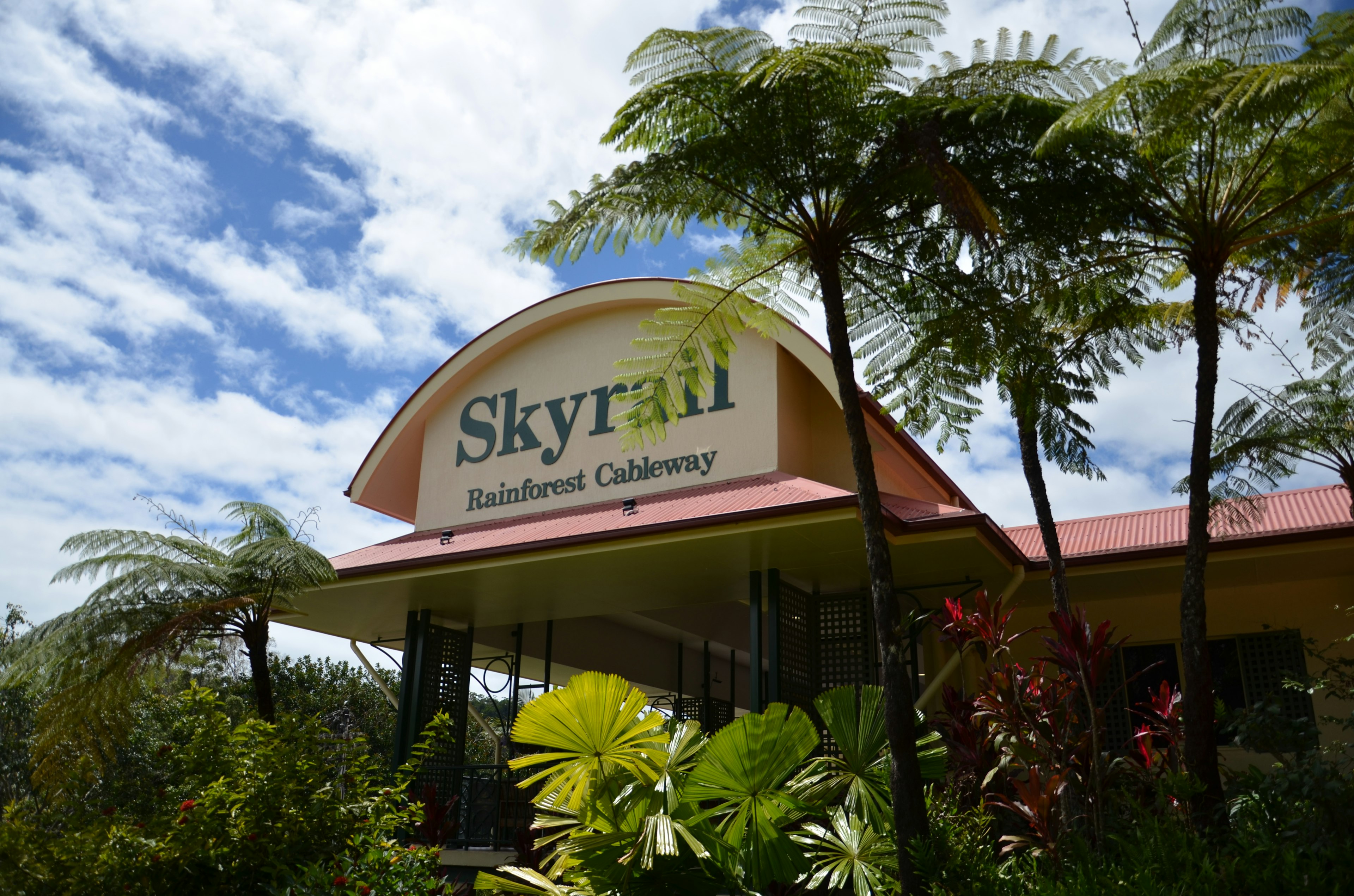 Skyrail Rainforest Cableway sign in a lush green setting