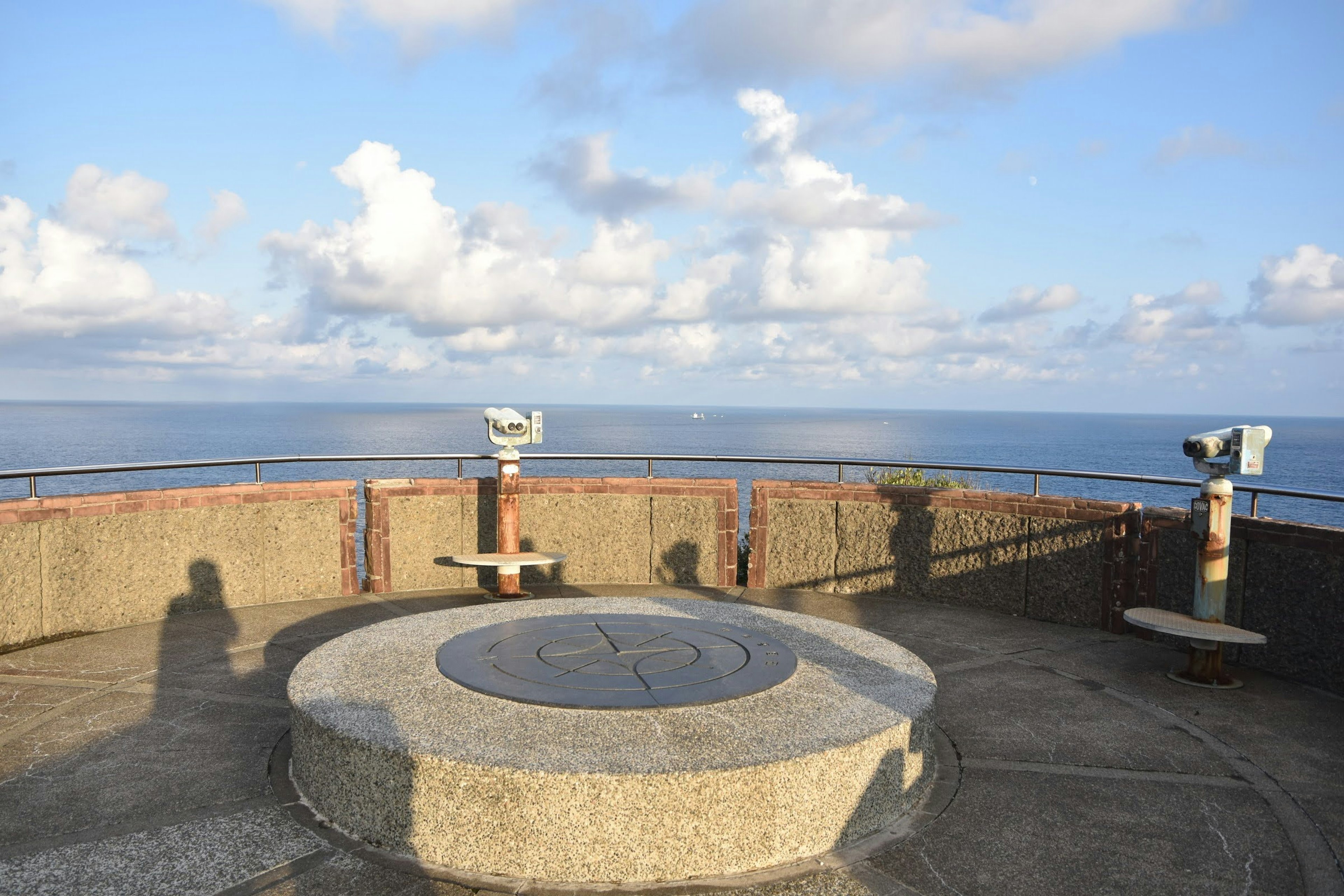 Scenic viewpoint overlooking the ocean with binoculars