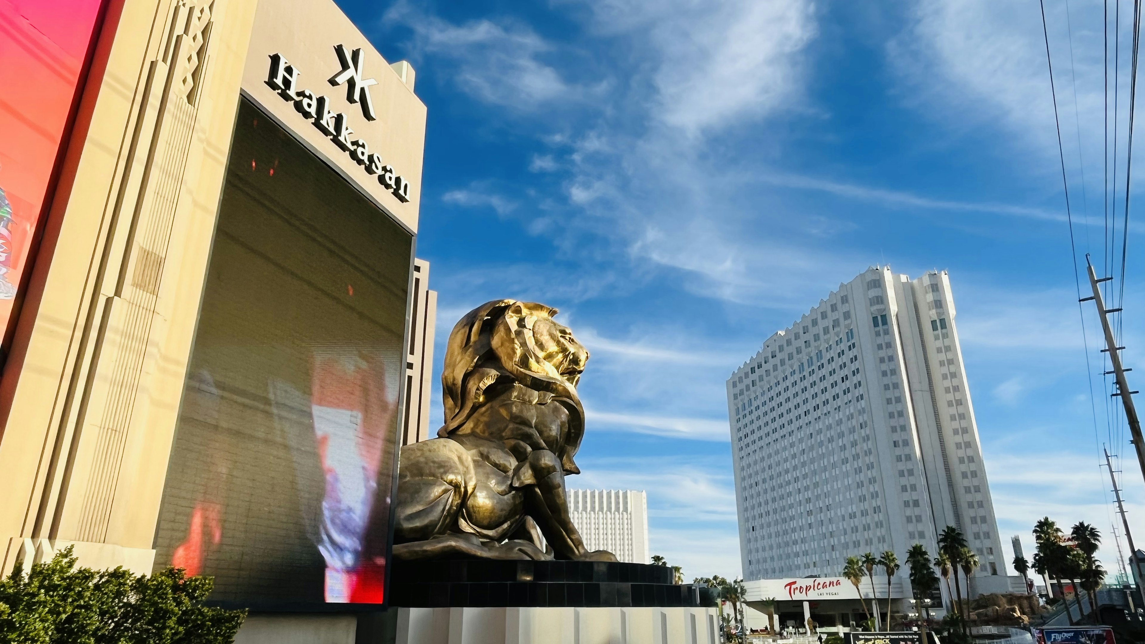 Golden lion statue in front of Bellagio Hotel with blue sky