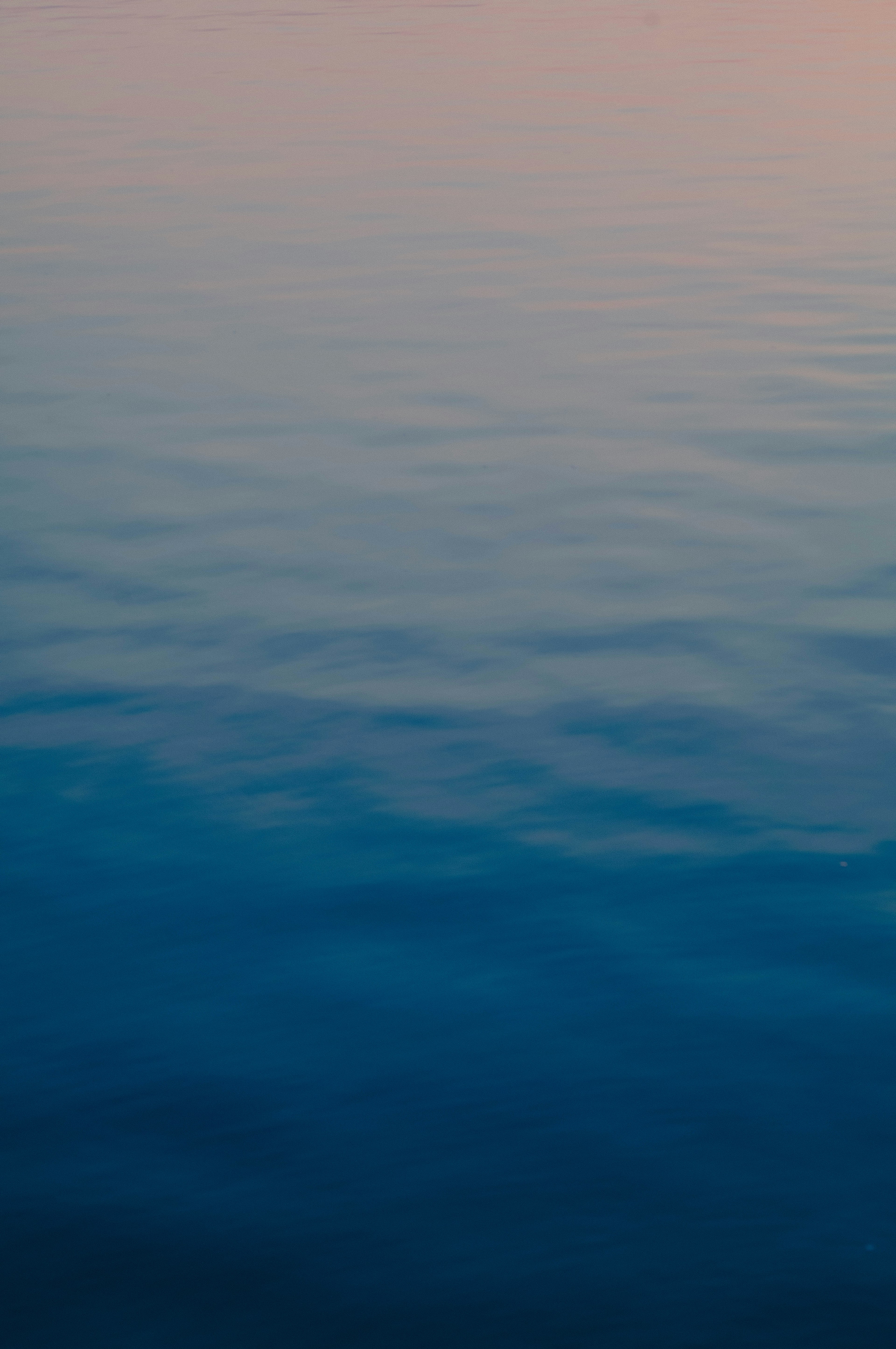 Calm water surface with soft color tones of the sea