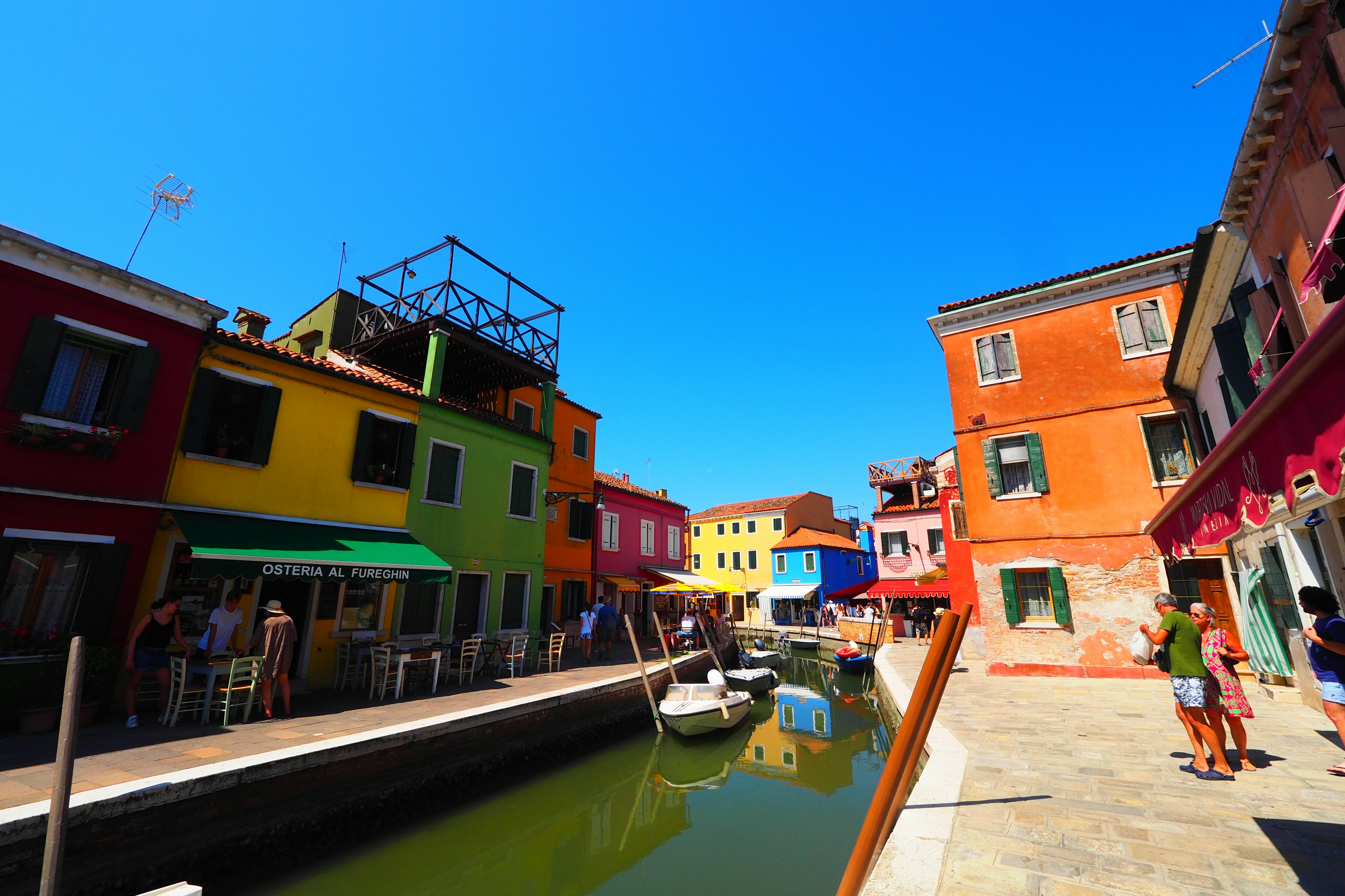 Colorful houses lining a canal in Burano