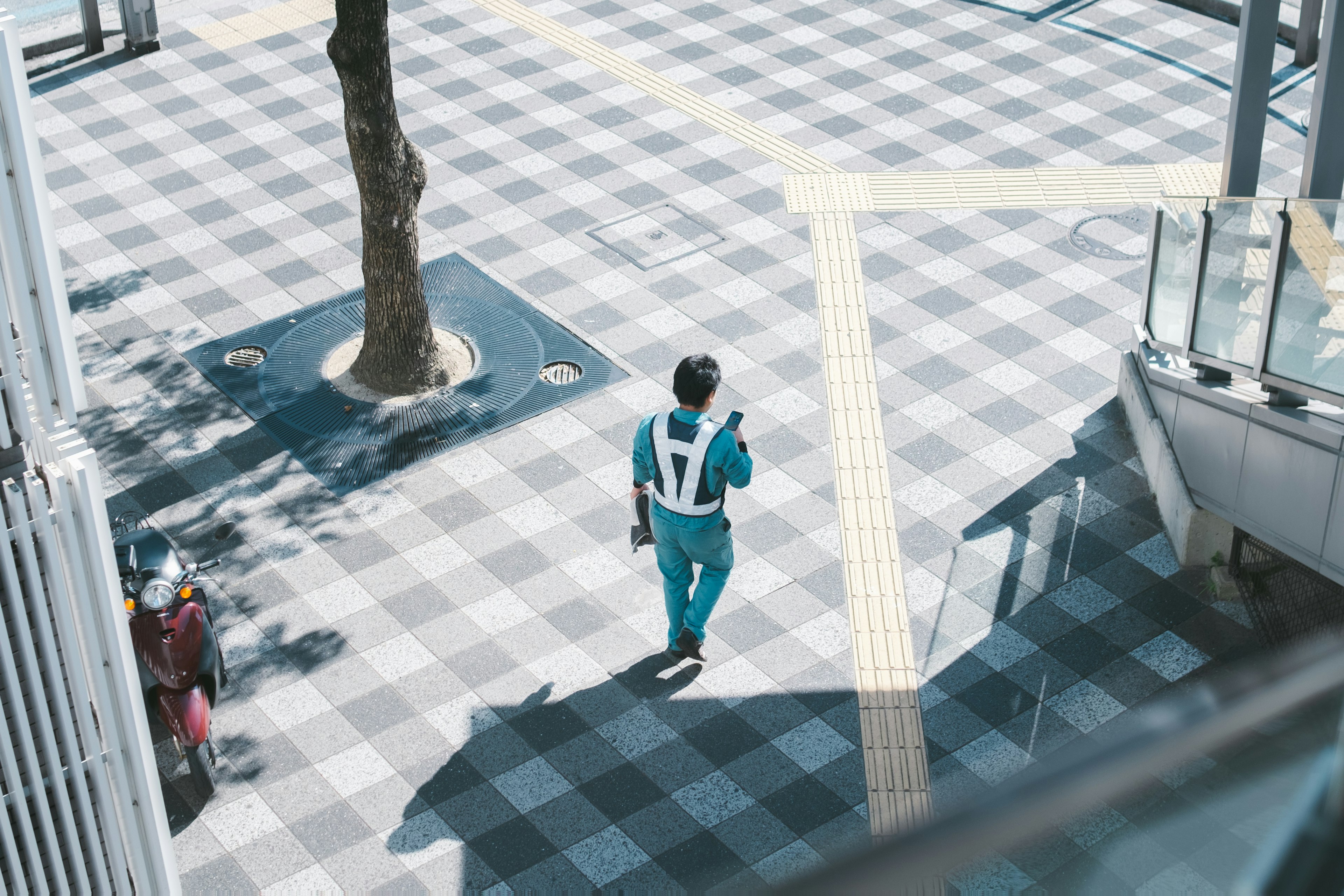 Un uomo in uniforme blu che cammina in un ambiente urbano