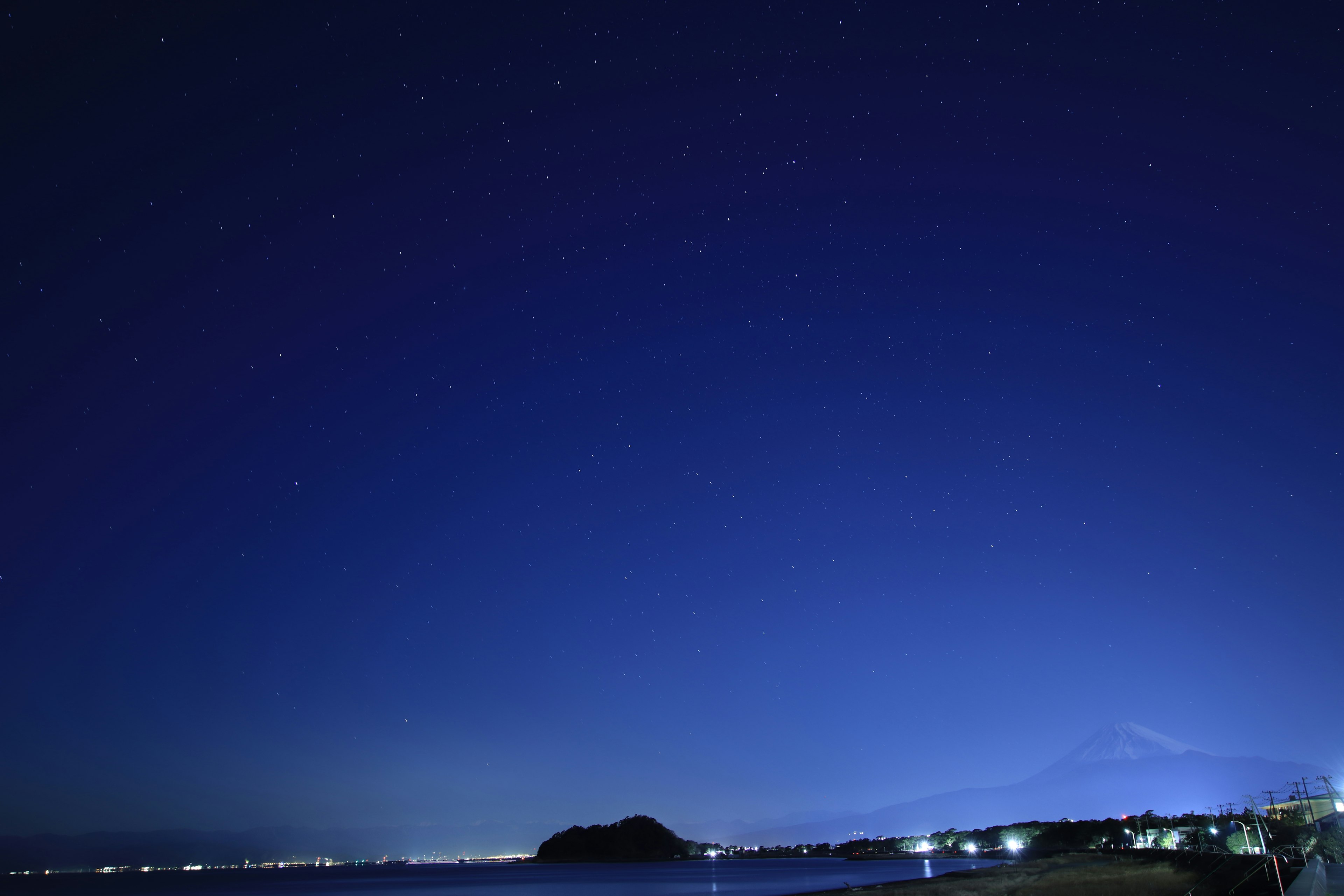 Beautiful night sky with stars over a coastal landscape