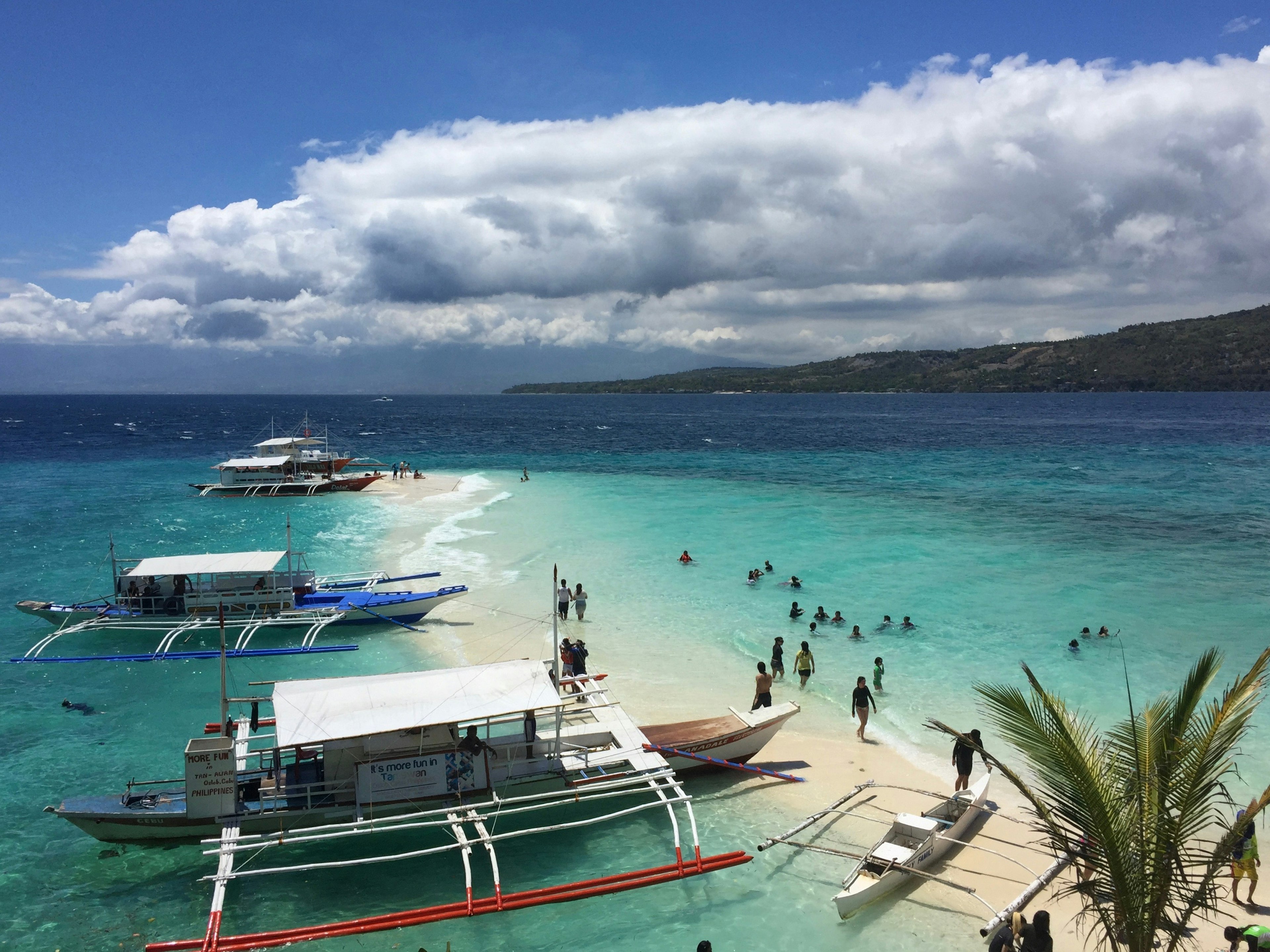 Beautiful beach with boats lined up and turquoise water