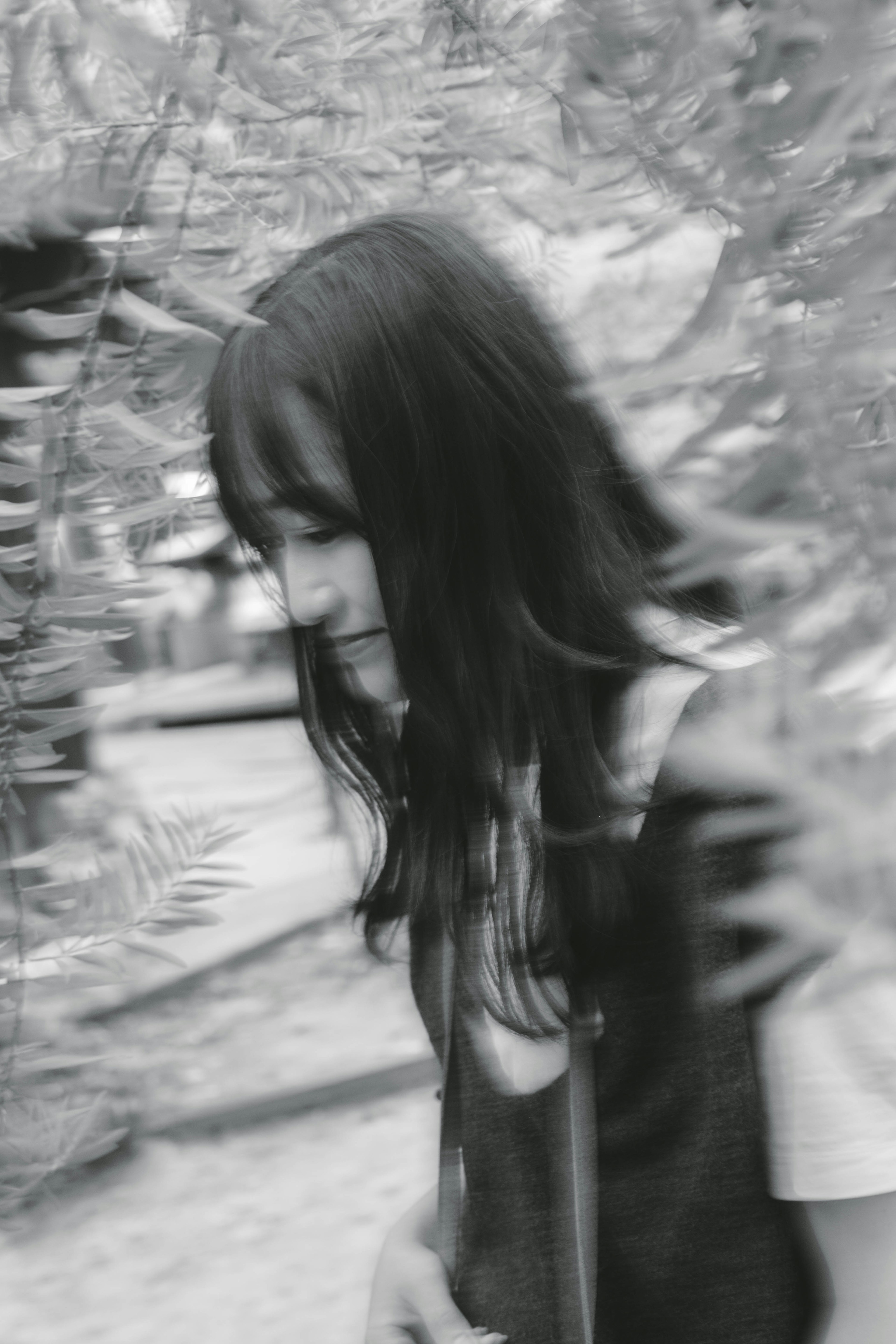 A girl walking in nature captured in black and white