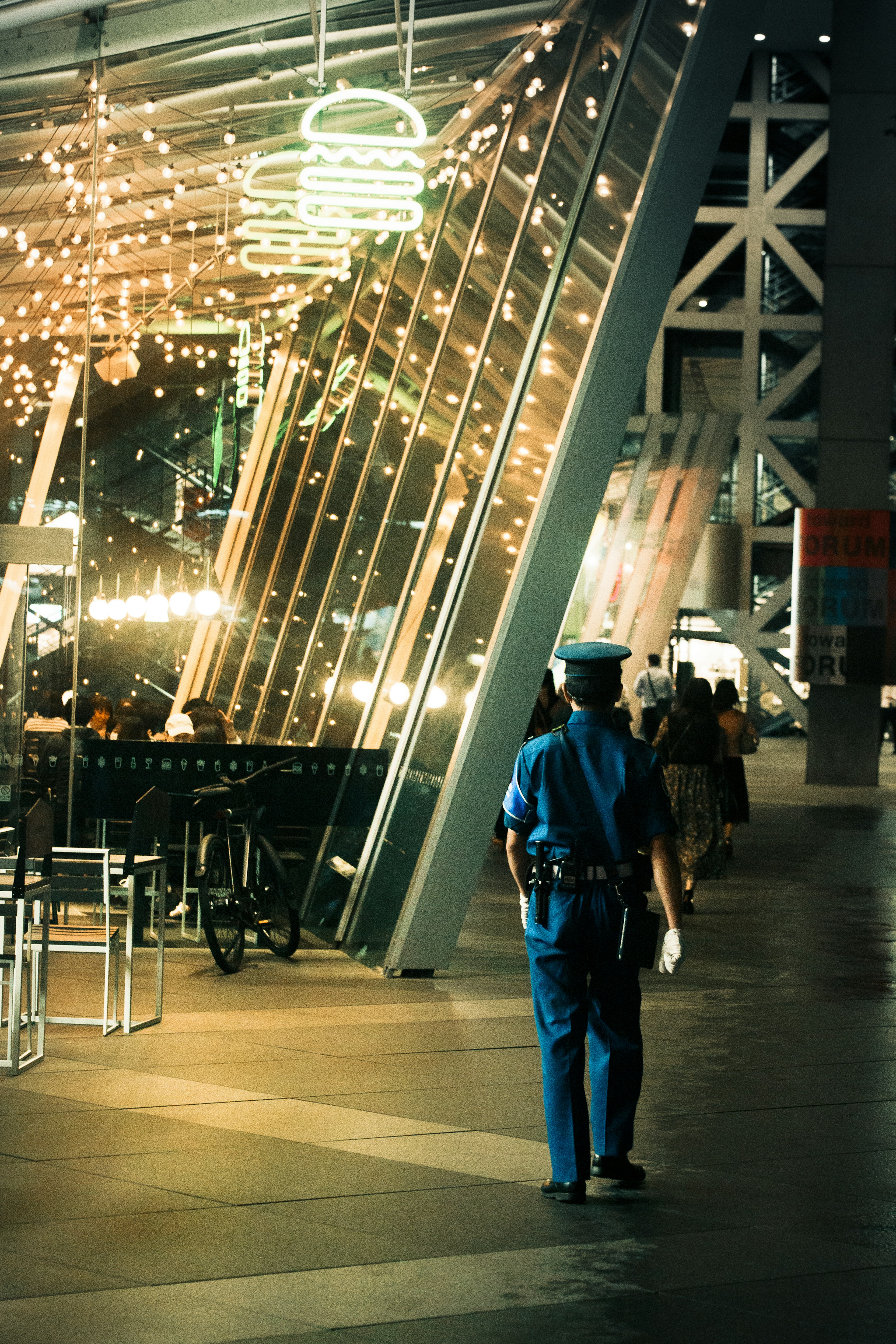 A police officer in a blue uniform walking in a city scene