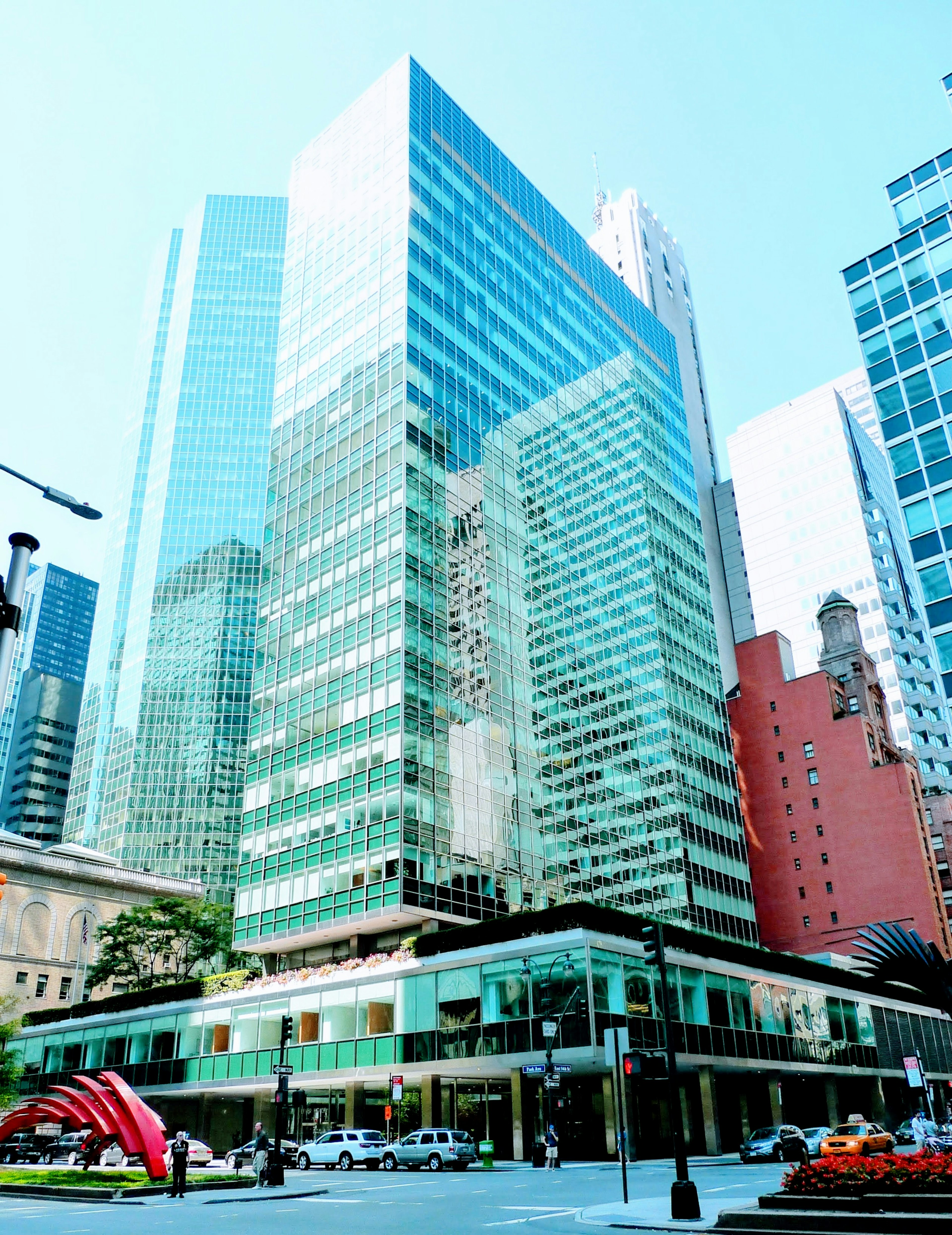 Cityscape featuring tall skyscrapers with glass facades and surrounding buildings