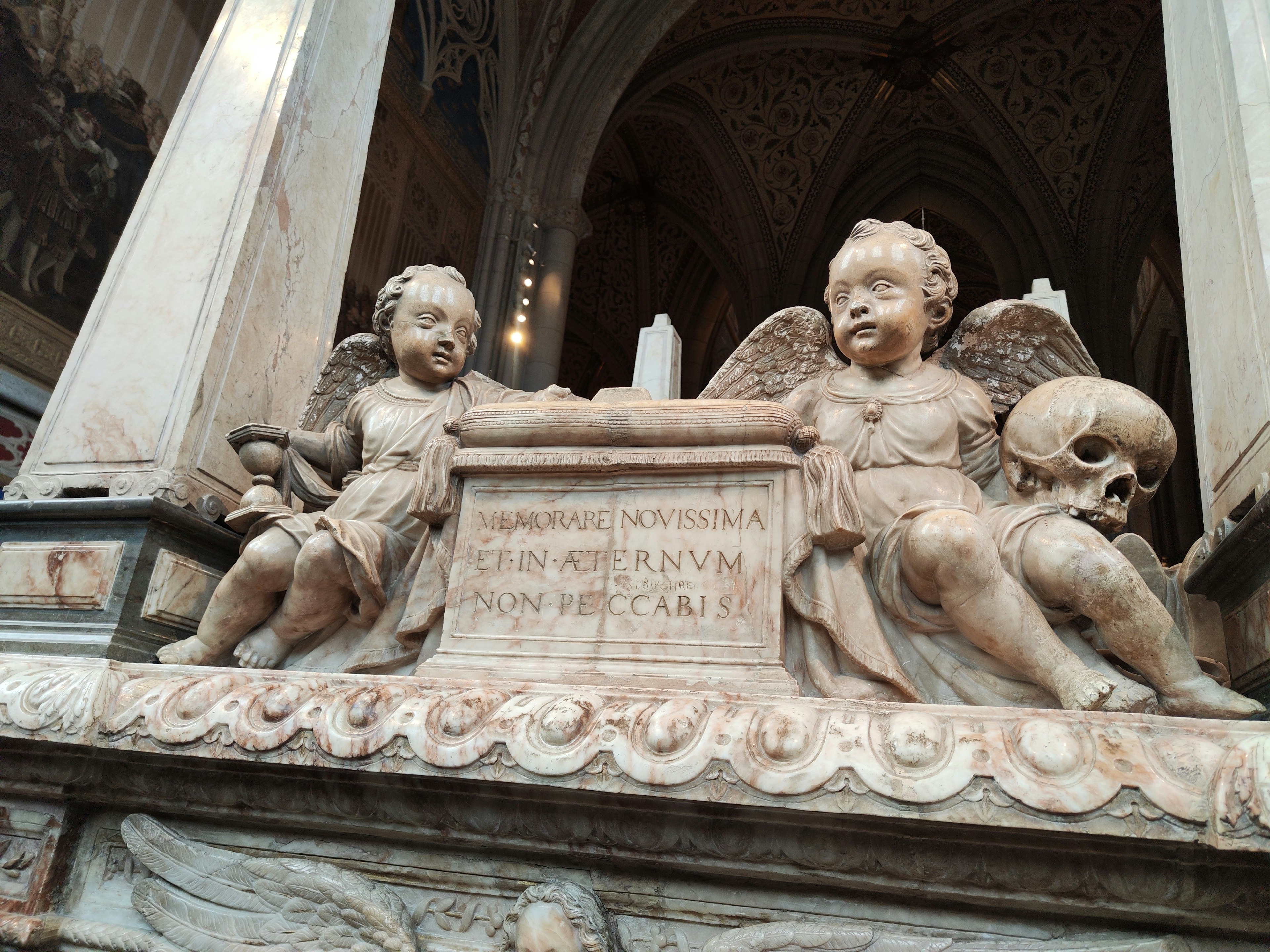 Detailed view of a tombstone with angel sculptures