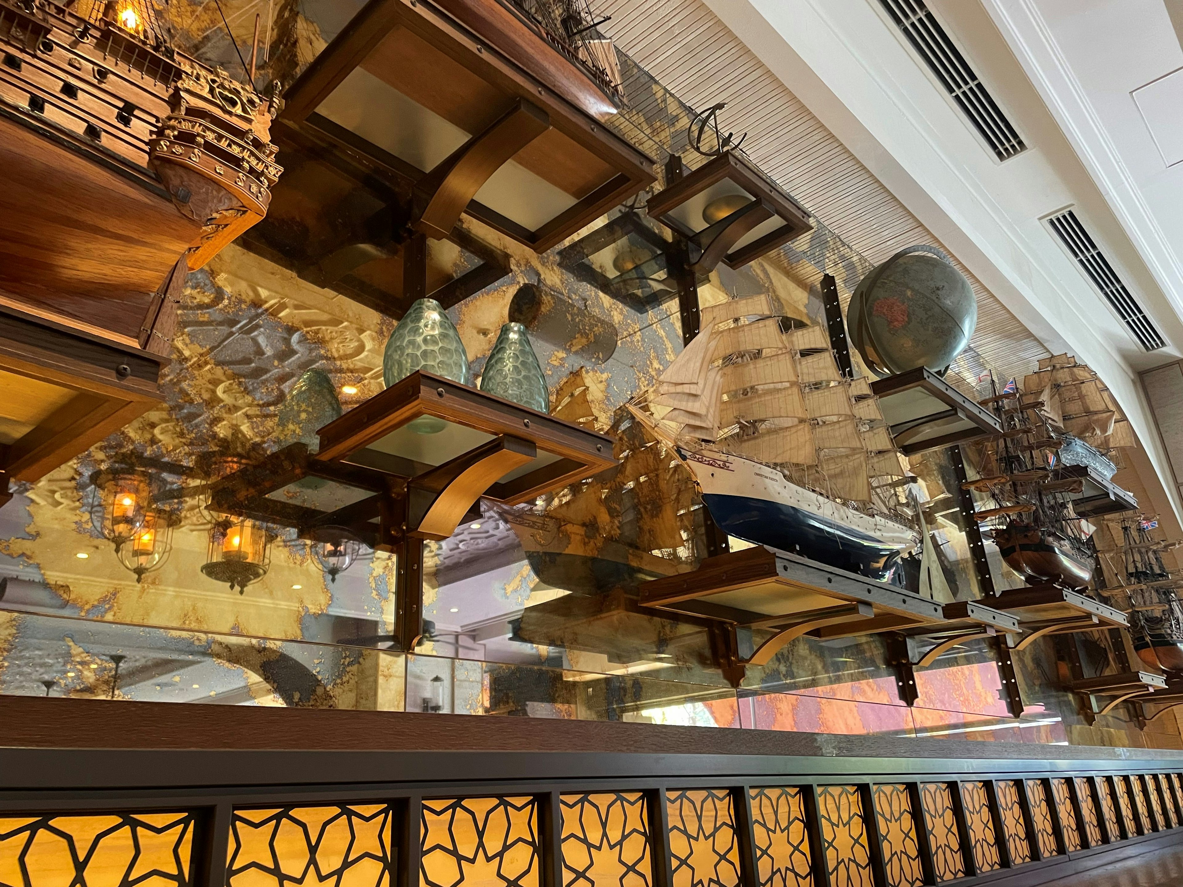 Image of wooden ship models and ornate decorations on a table