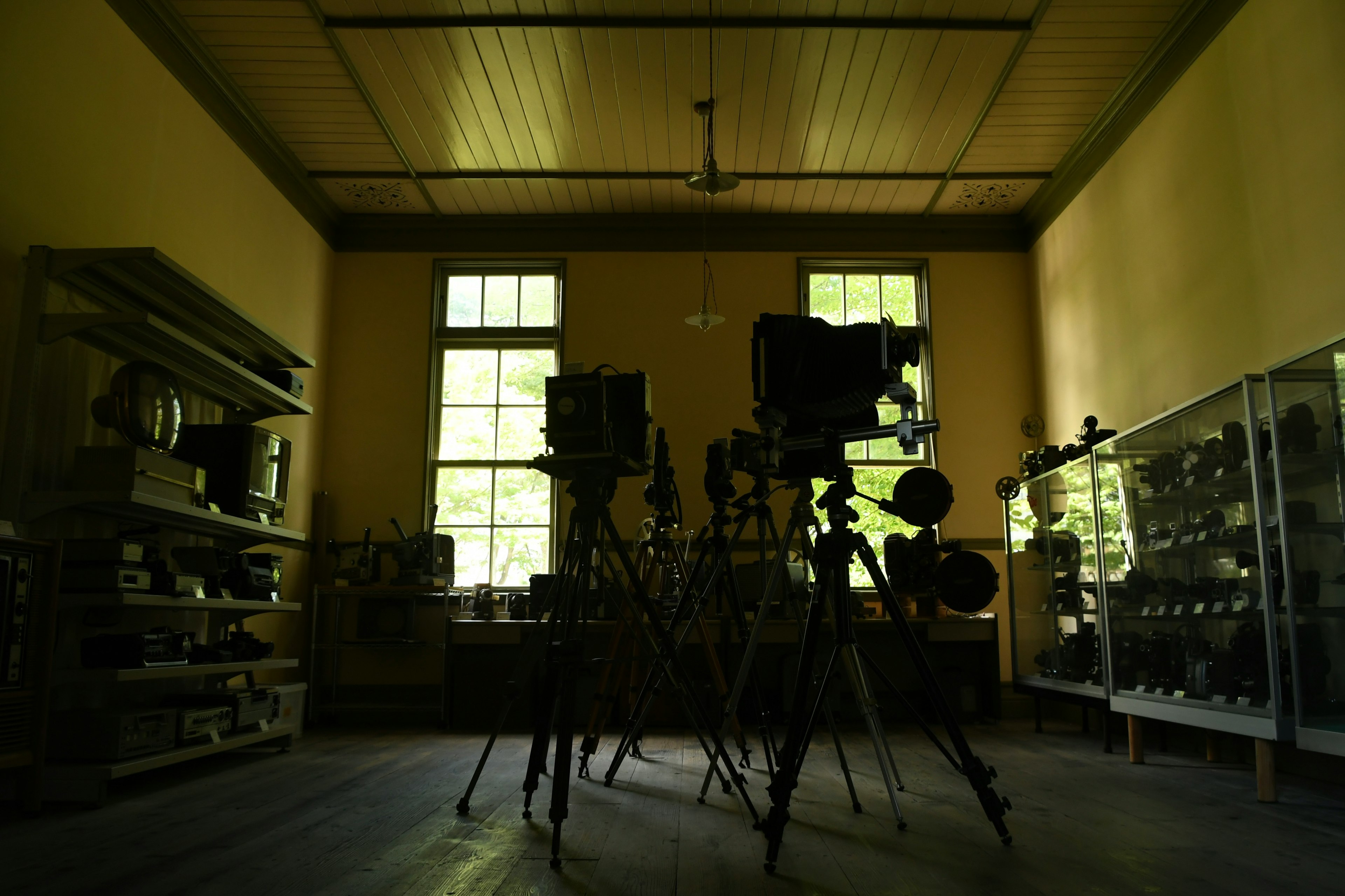 Interior of a museum featuring old cameras on tripods