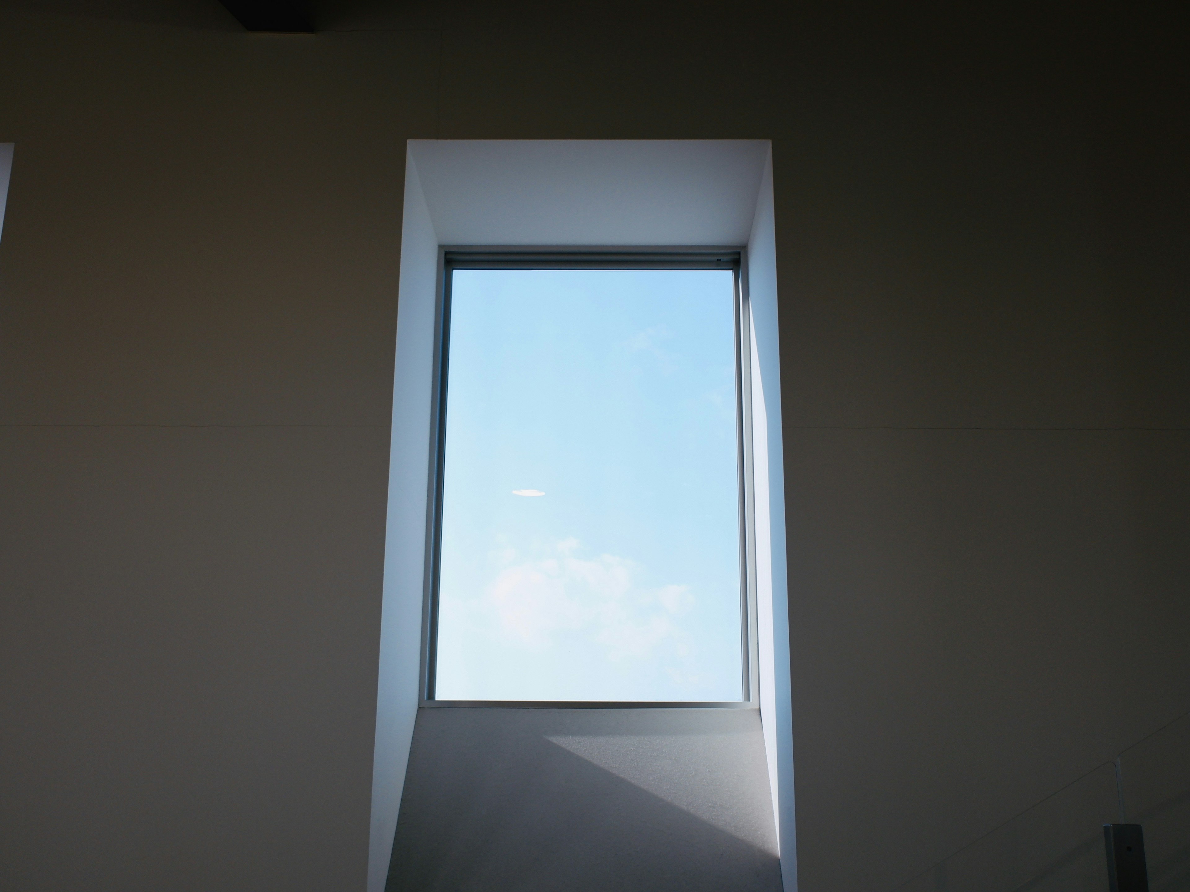 Narrow window showcasing a blue sky