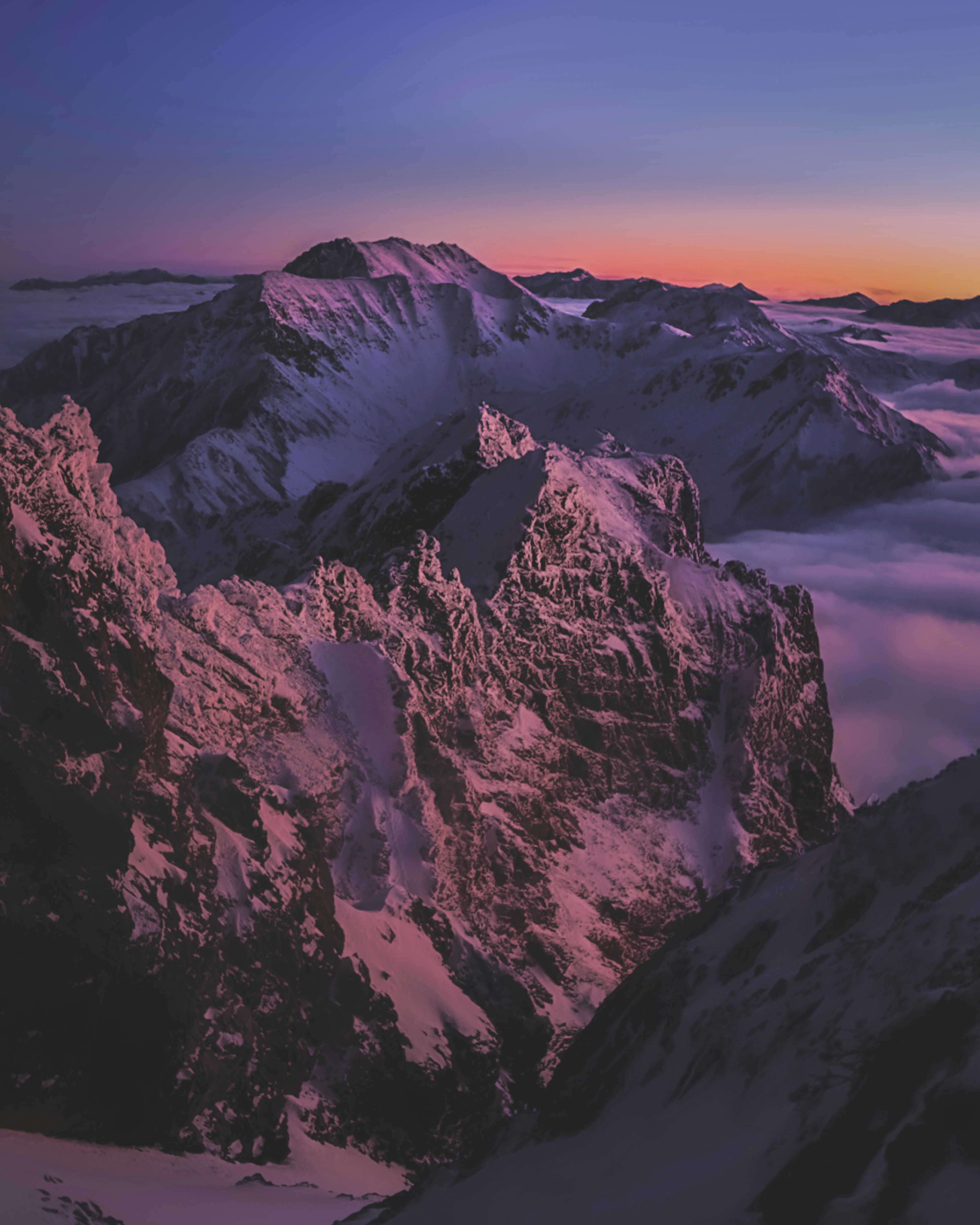 Mountainous landscape with a sea of clouds during sunset