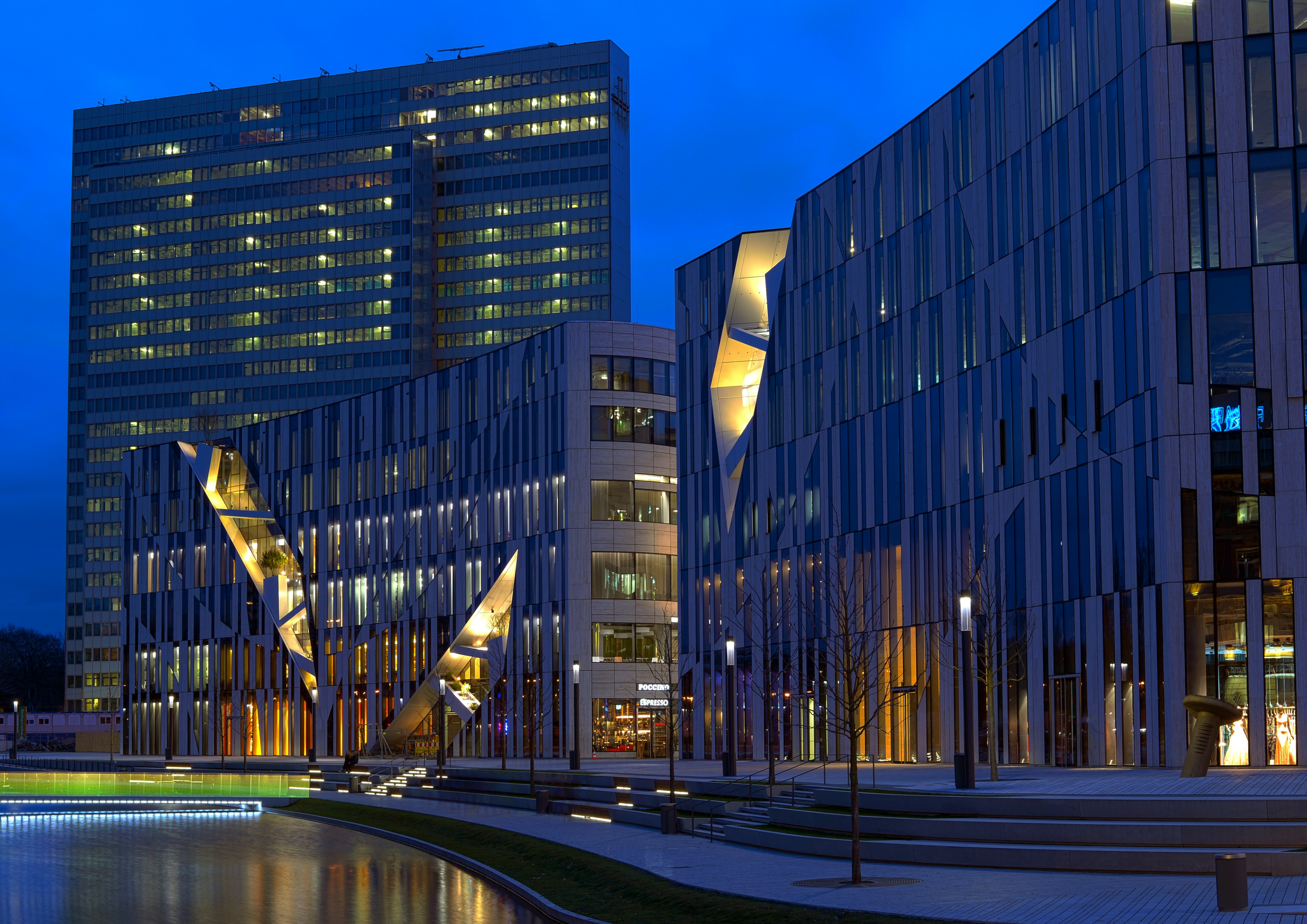 Modern architectural building illuminated at night under a blue sky