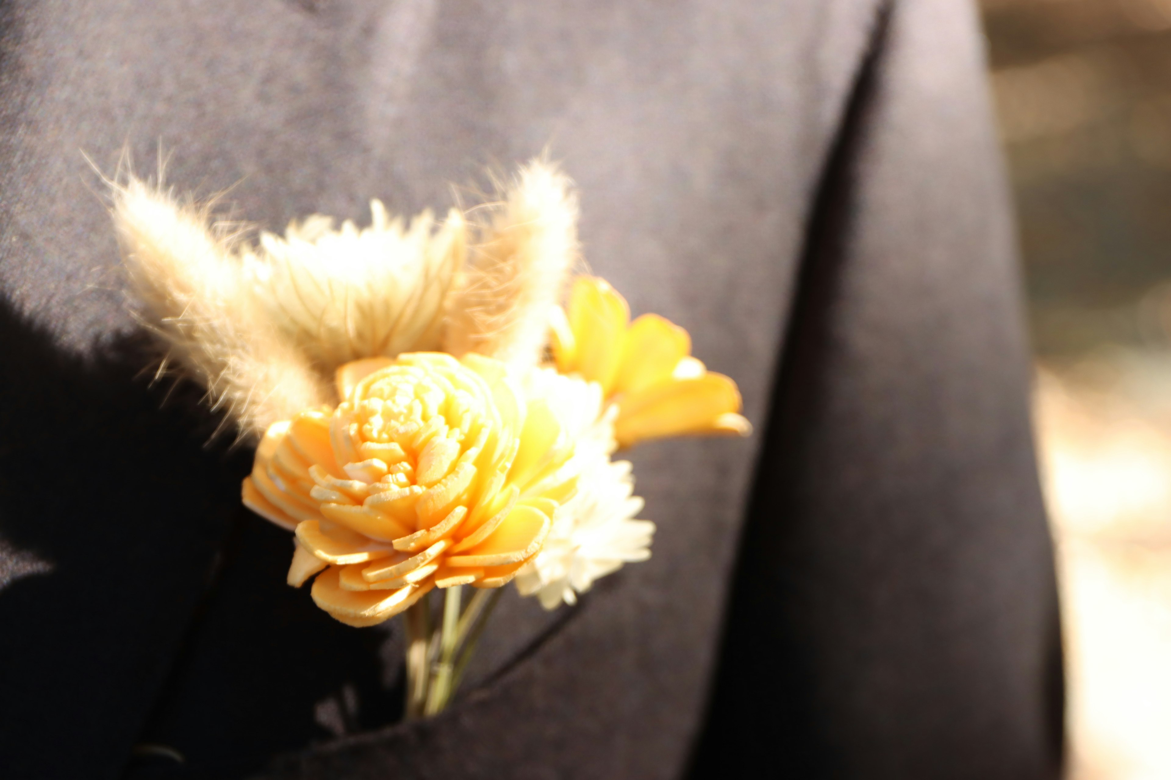 Fluffy ear-like decoration with orange flowers in a pocket