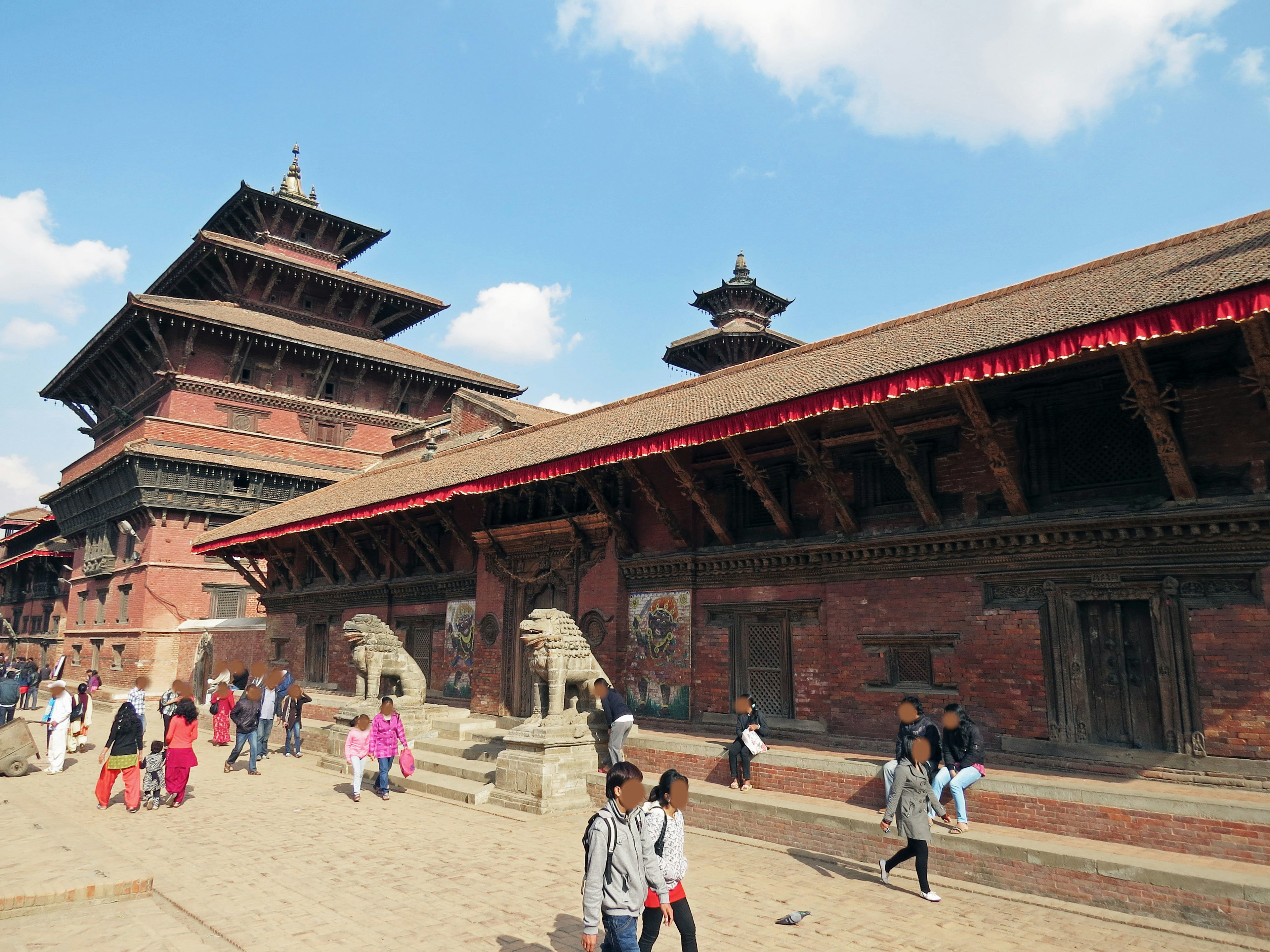 Traditional temple complex in Bhaktapur with tourists walking