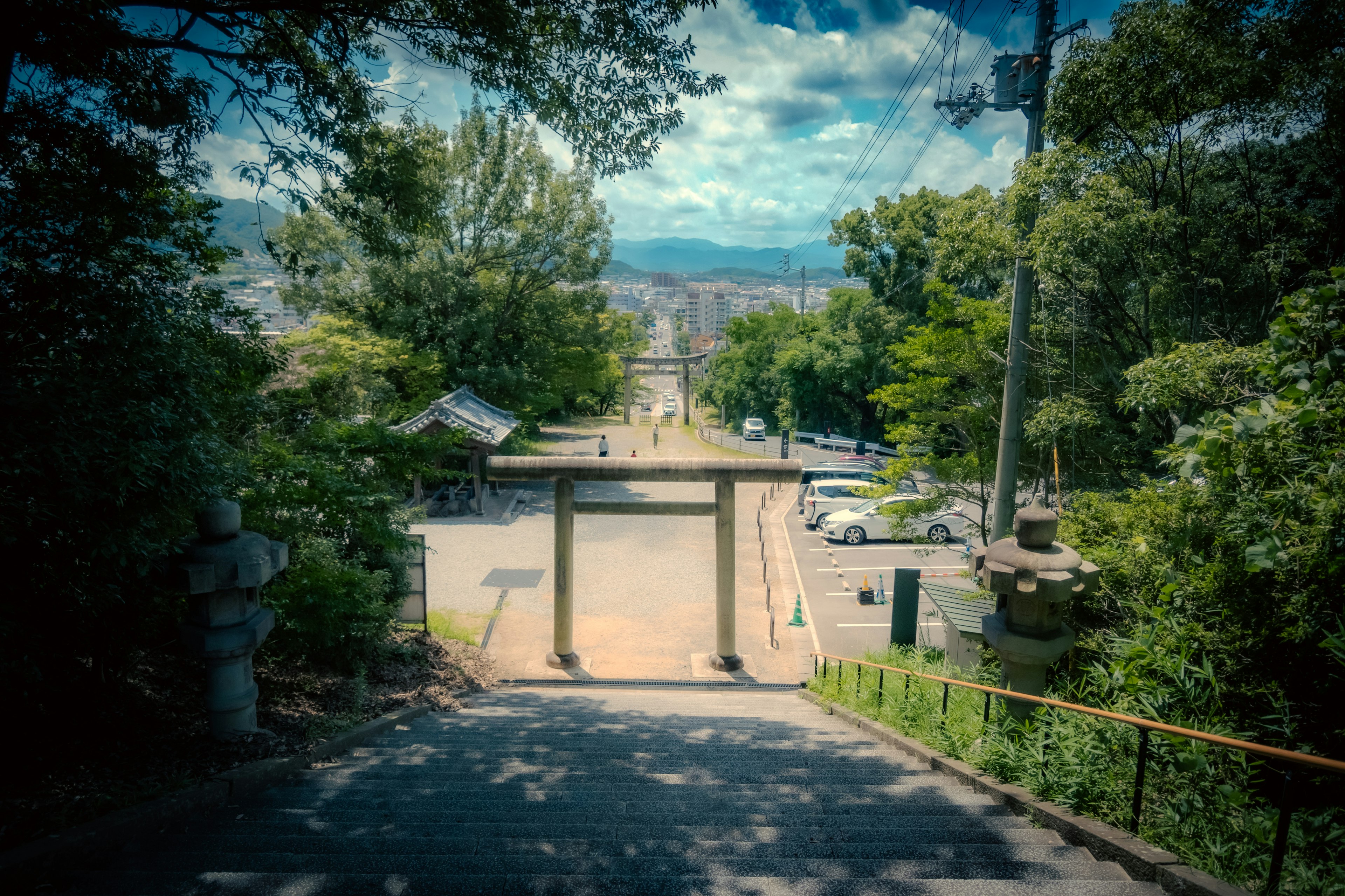 Cổng torii được bao quanh bởi cây cối với con đường rộng