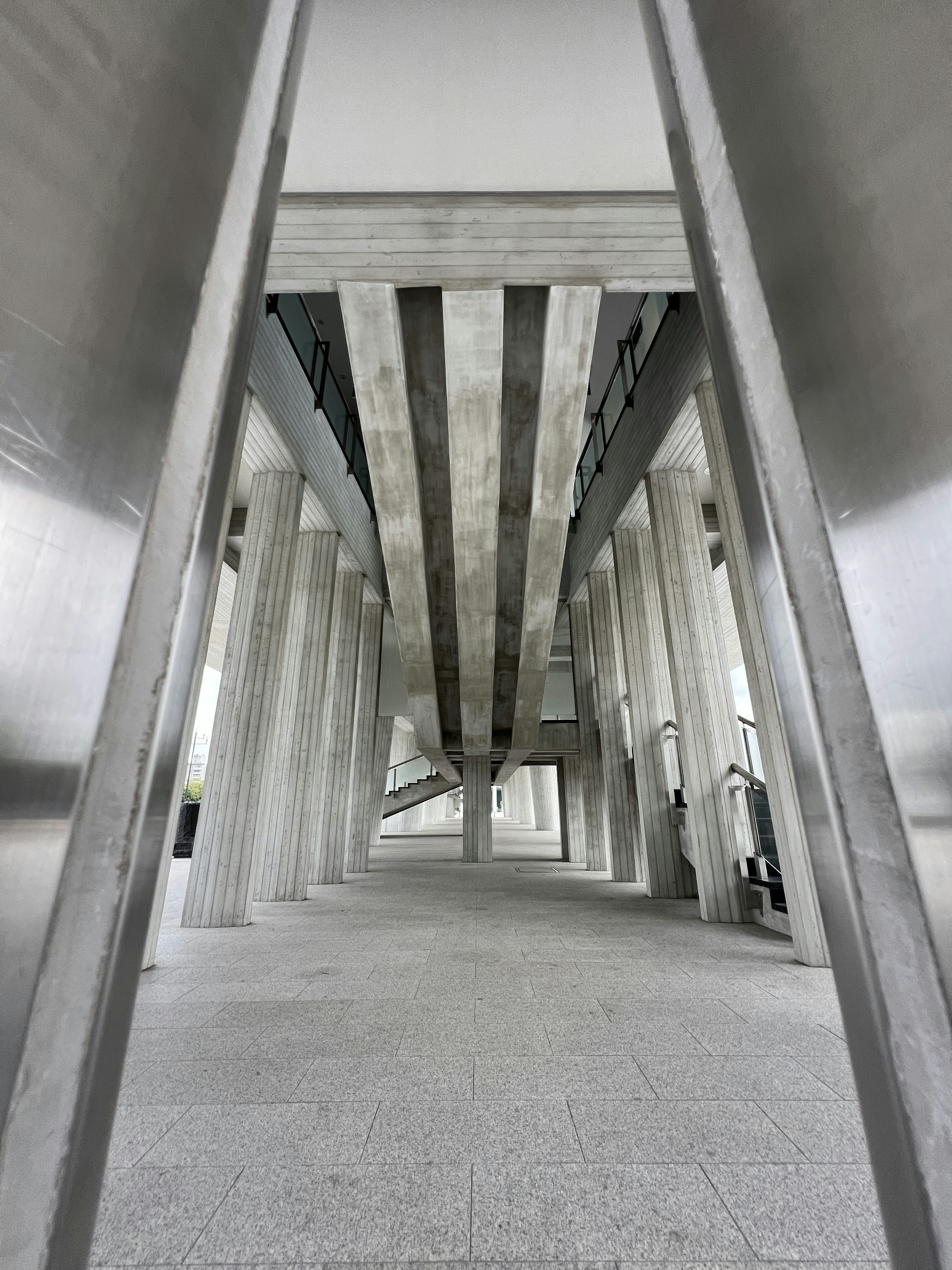 Modern architectural interior viewed through concrete and metal structures