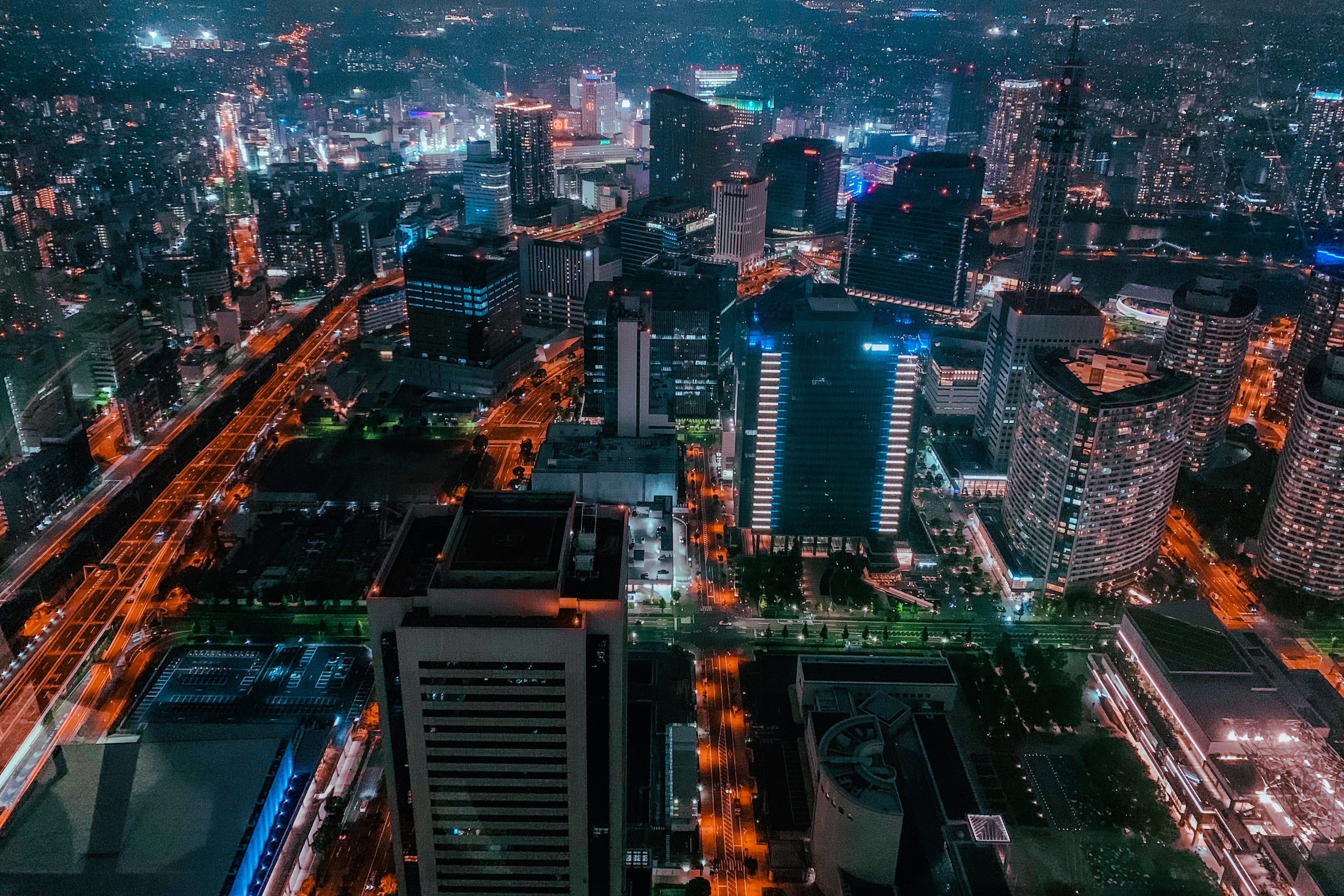 Nighttime city skyline featuring skyscrapers and illuminated roads