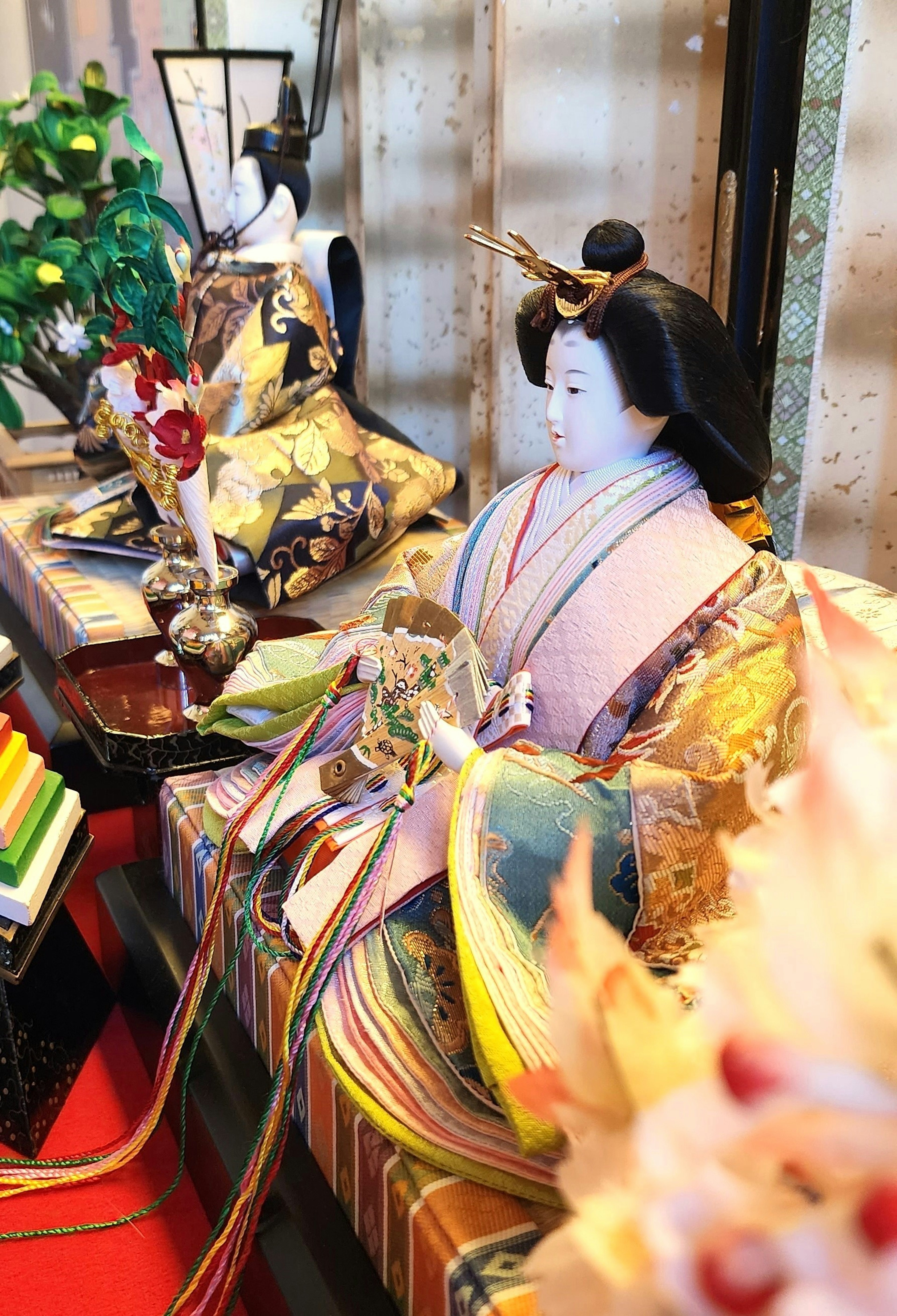 Colorful Japanese hina dolls displayed on a decorative stand