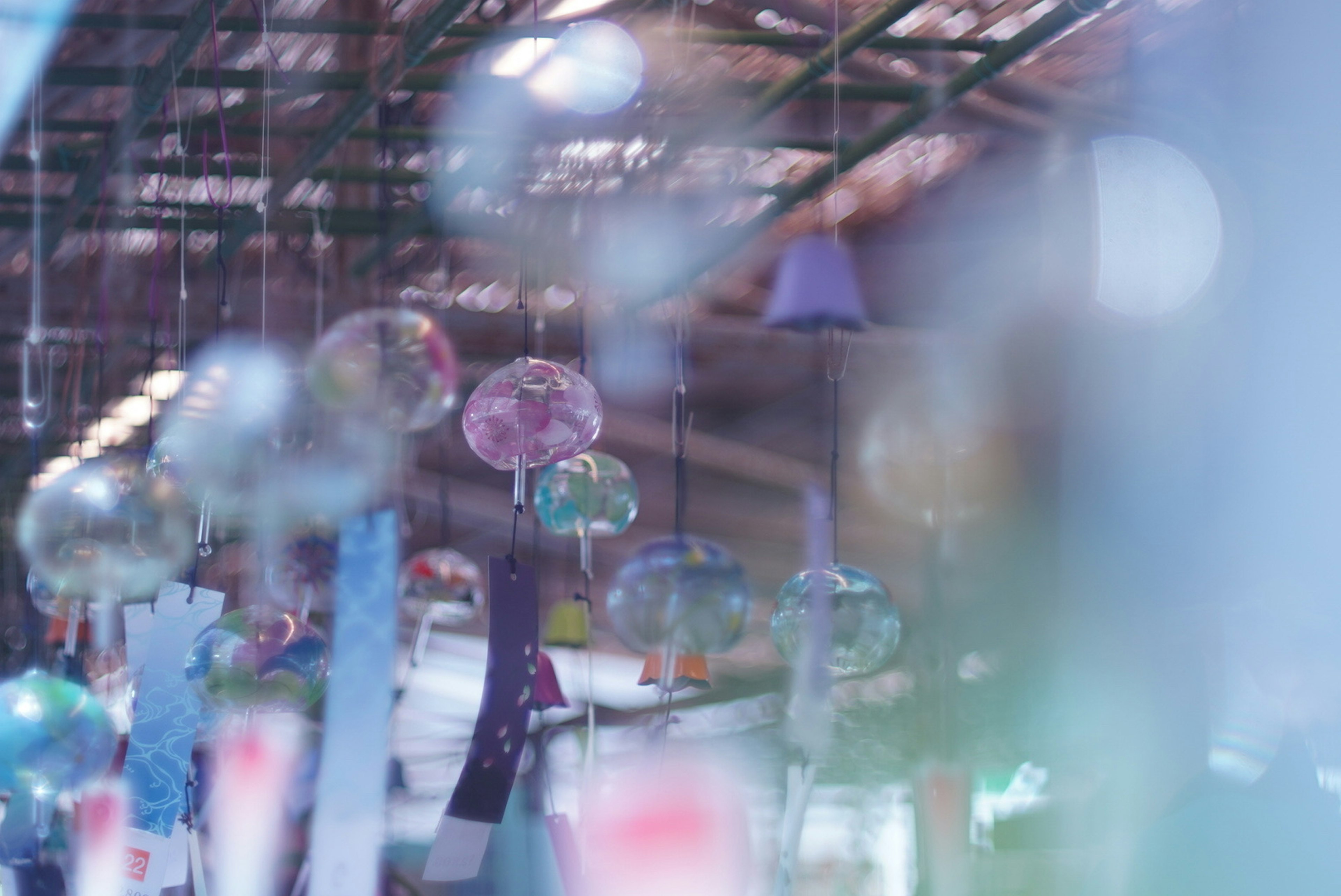 Blurred image of colorful glass objects hanging in a space