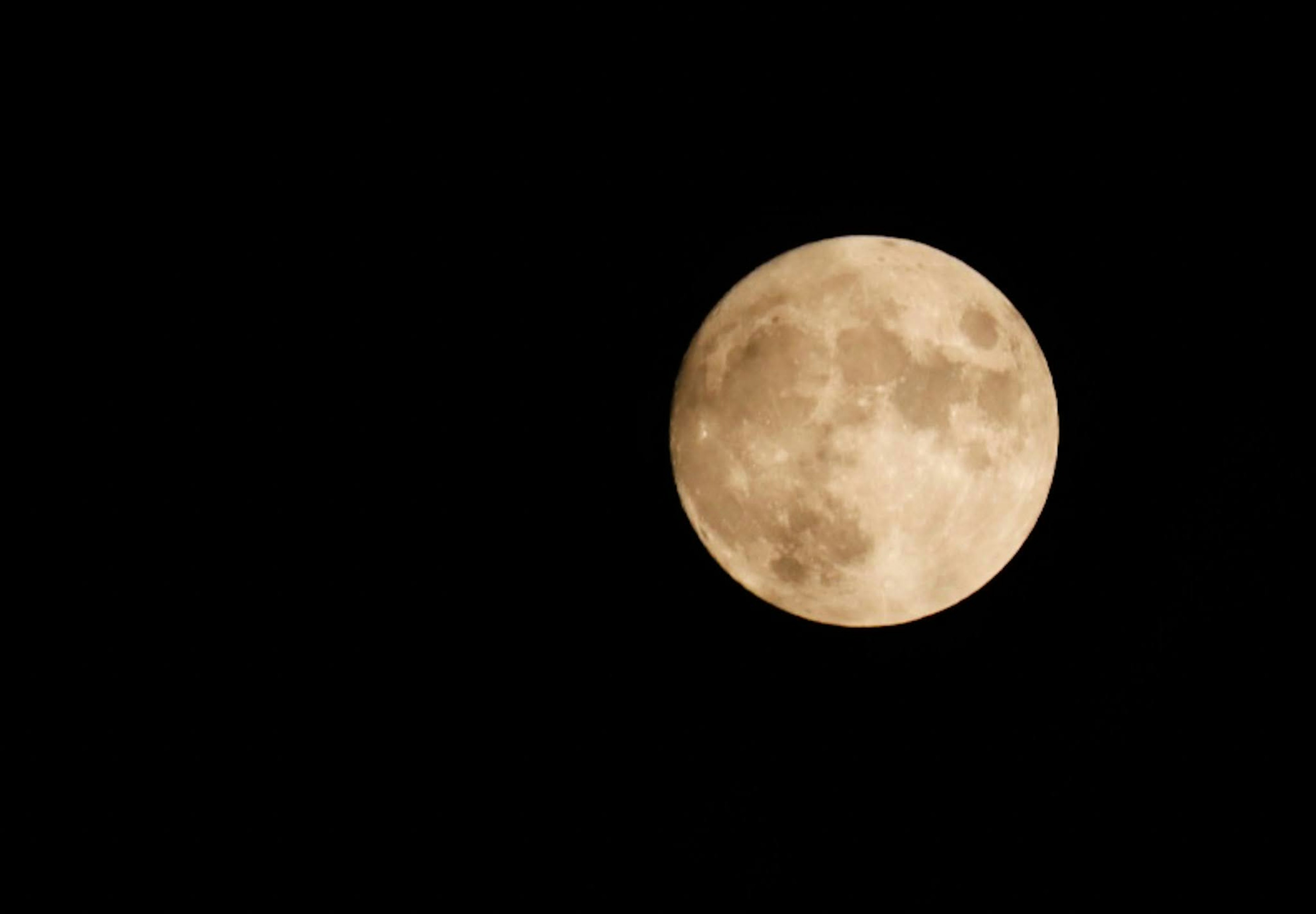 Full moon glowing against a dark sky