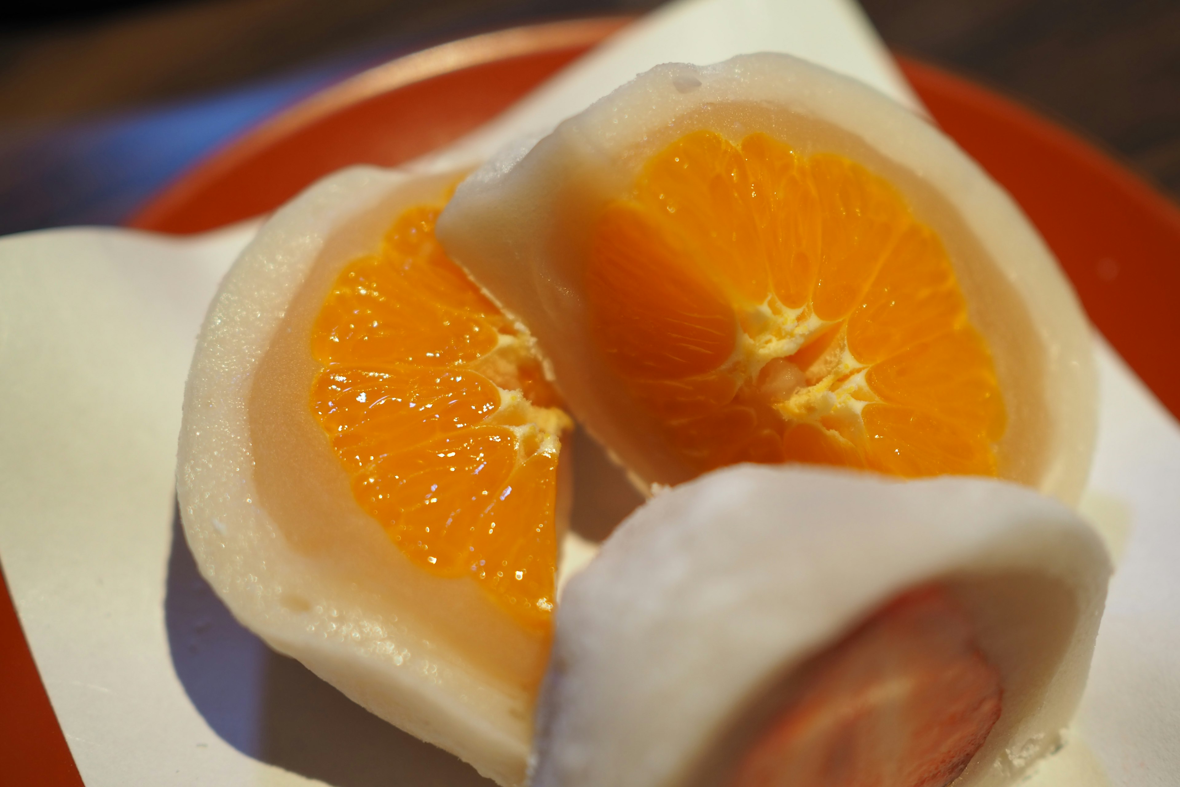 Close-up of orange and mochi dessert