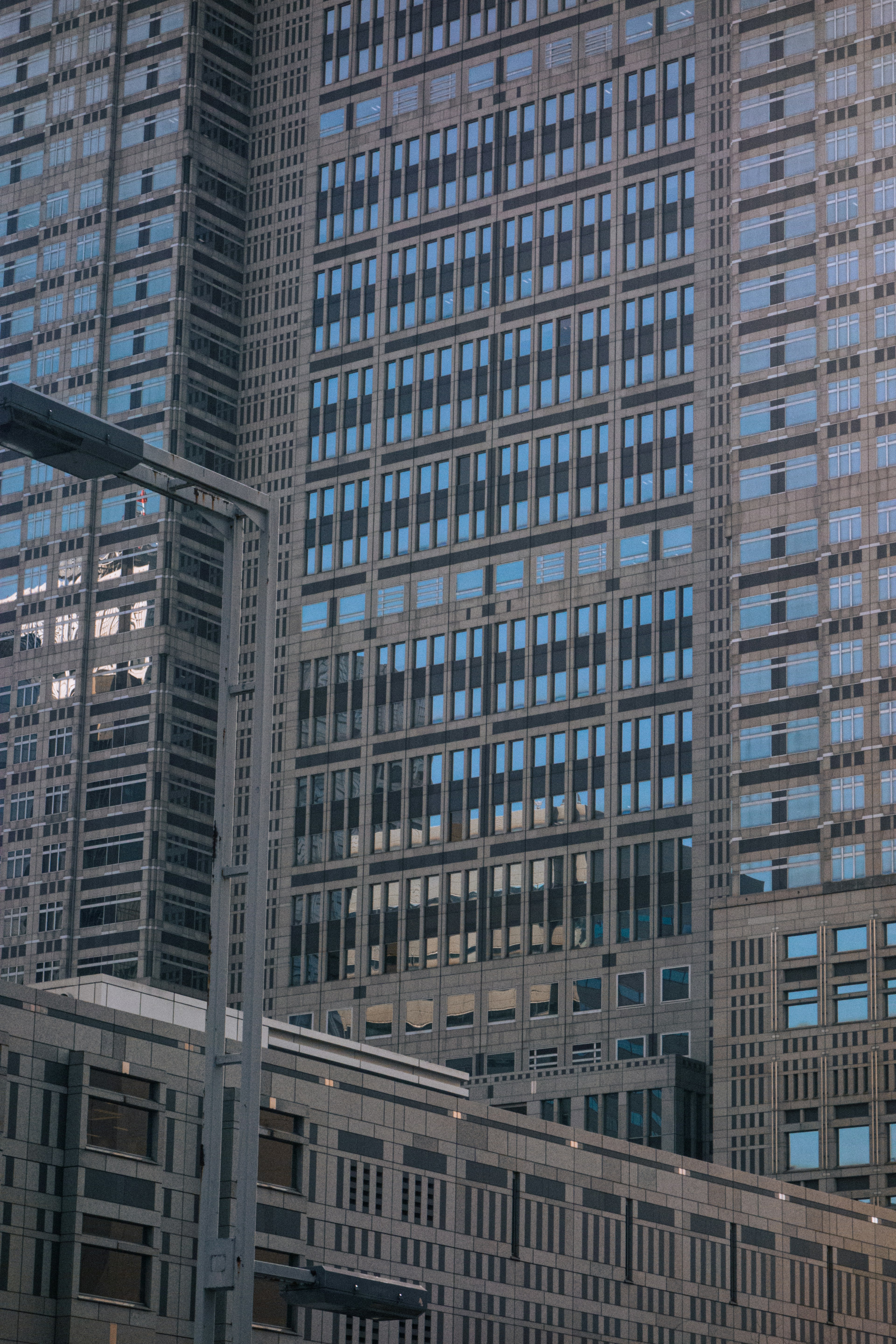 Close-up of a skyscraper featuring reflective windows and unique architecture