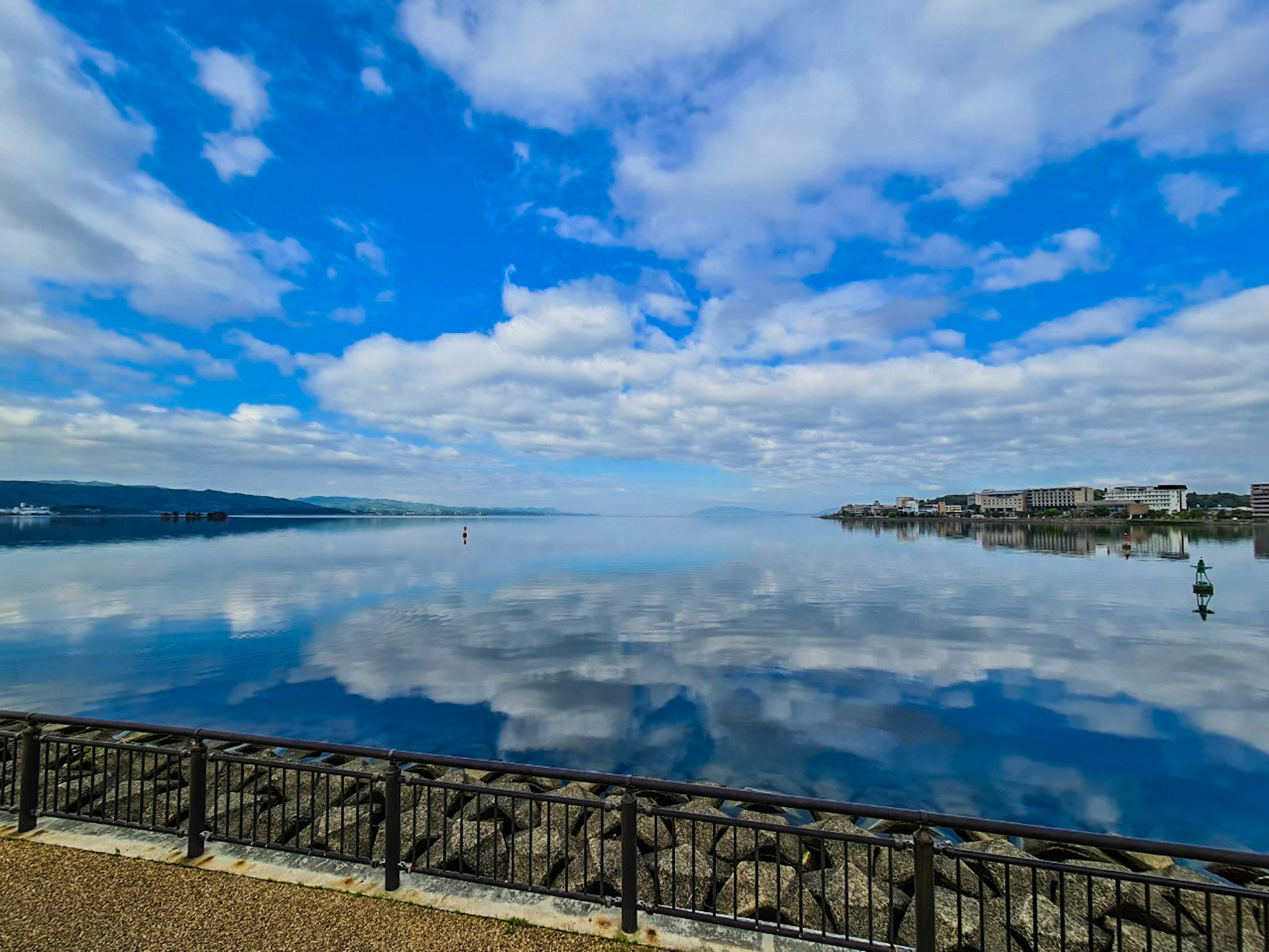 Calm lake reflecting blue sky and clouds