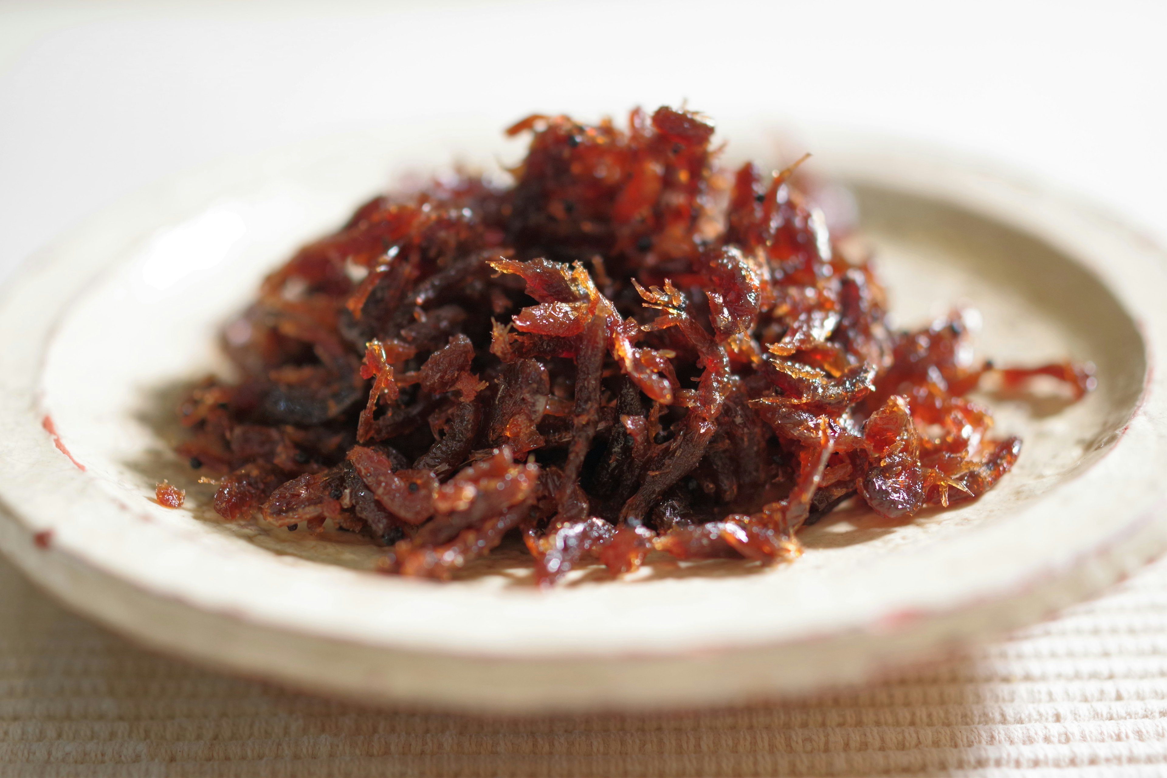 Shredded sweet and savory fish flakes on a plate