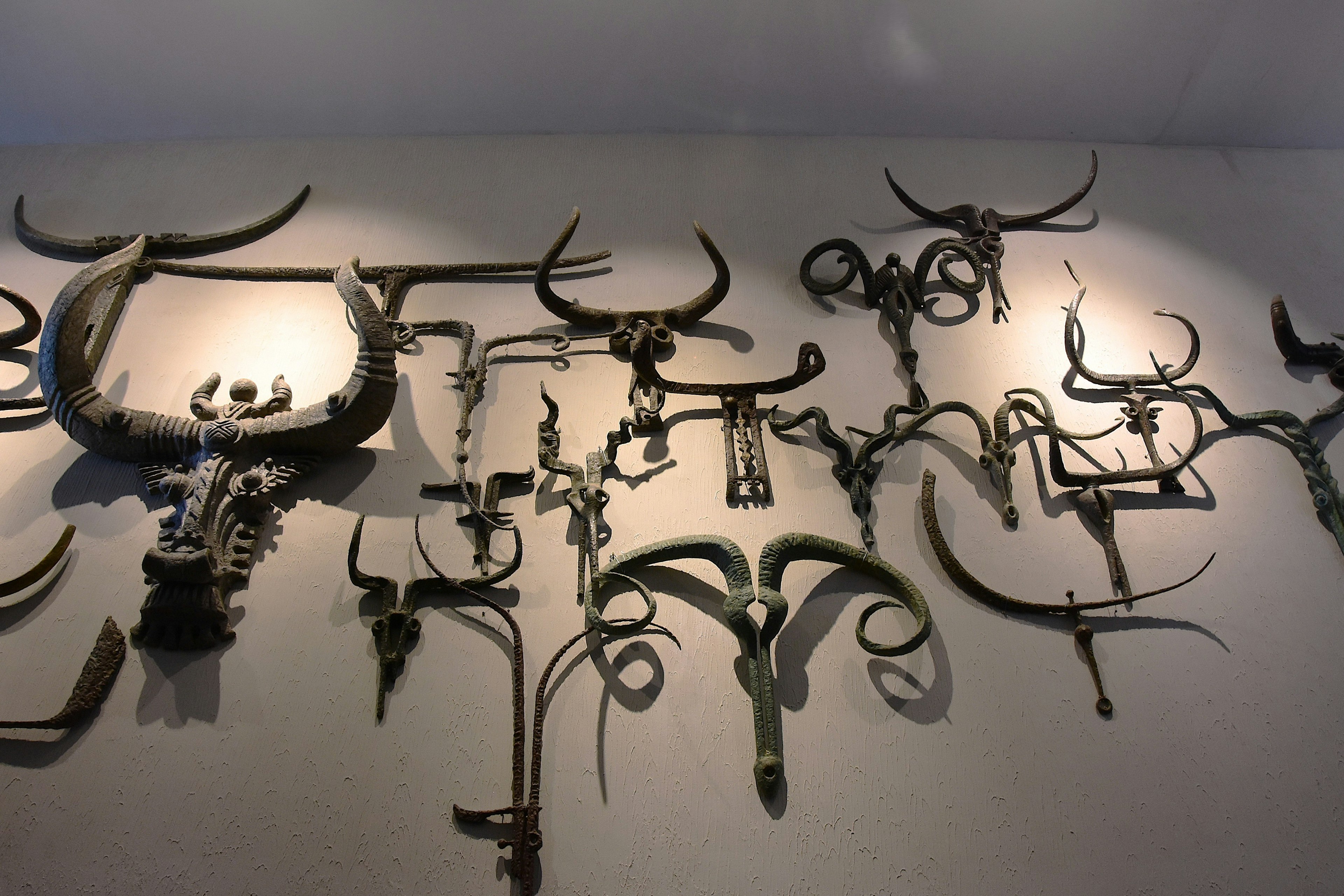 Various decorative horn objects displayed on a wall