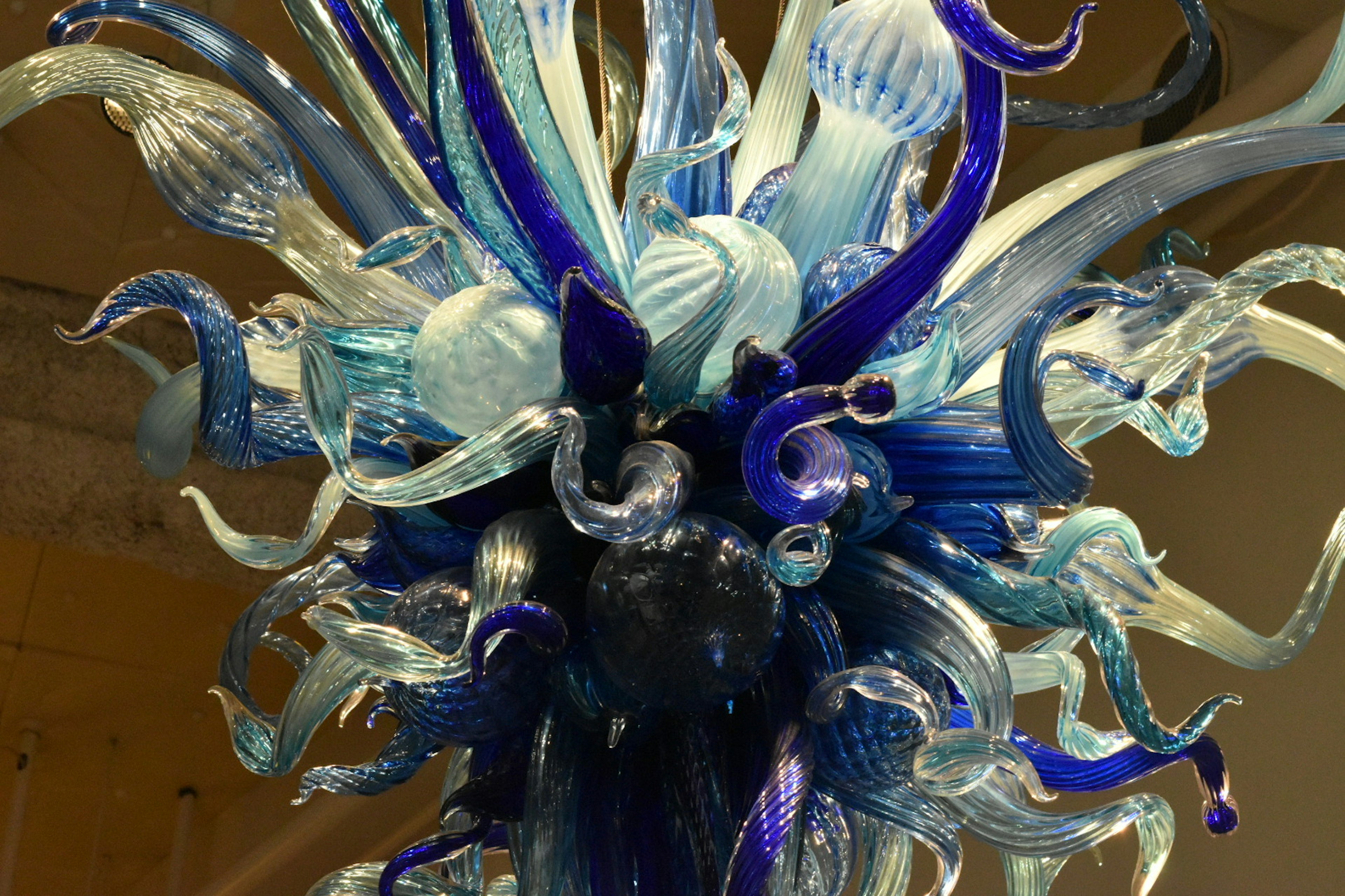 A beautiful chandelier made of blue and clear glass details