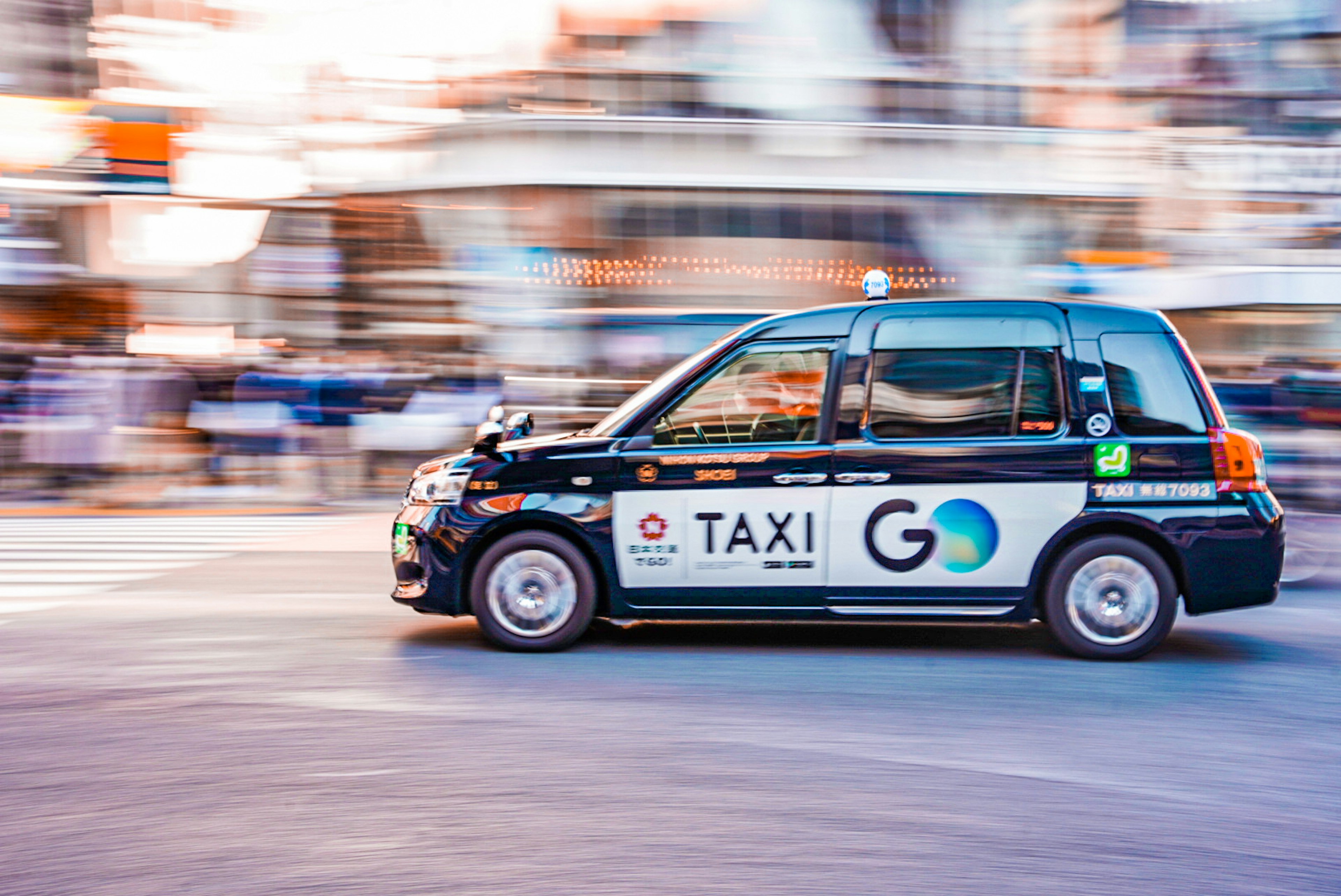 A taxi driving through a bustling street with motion blur