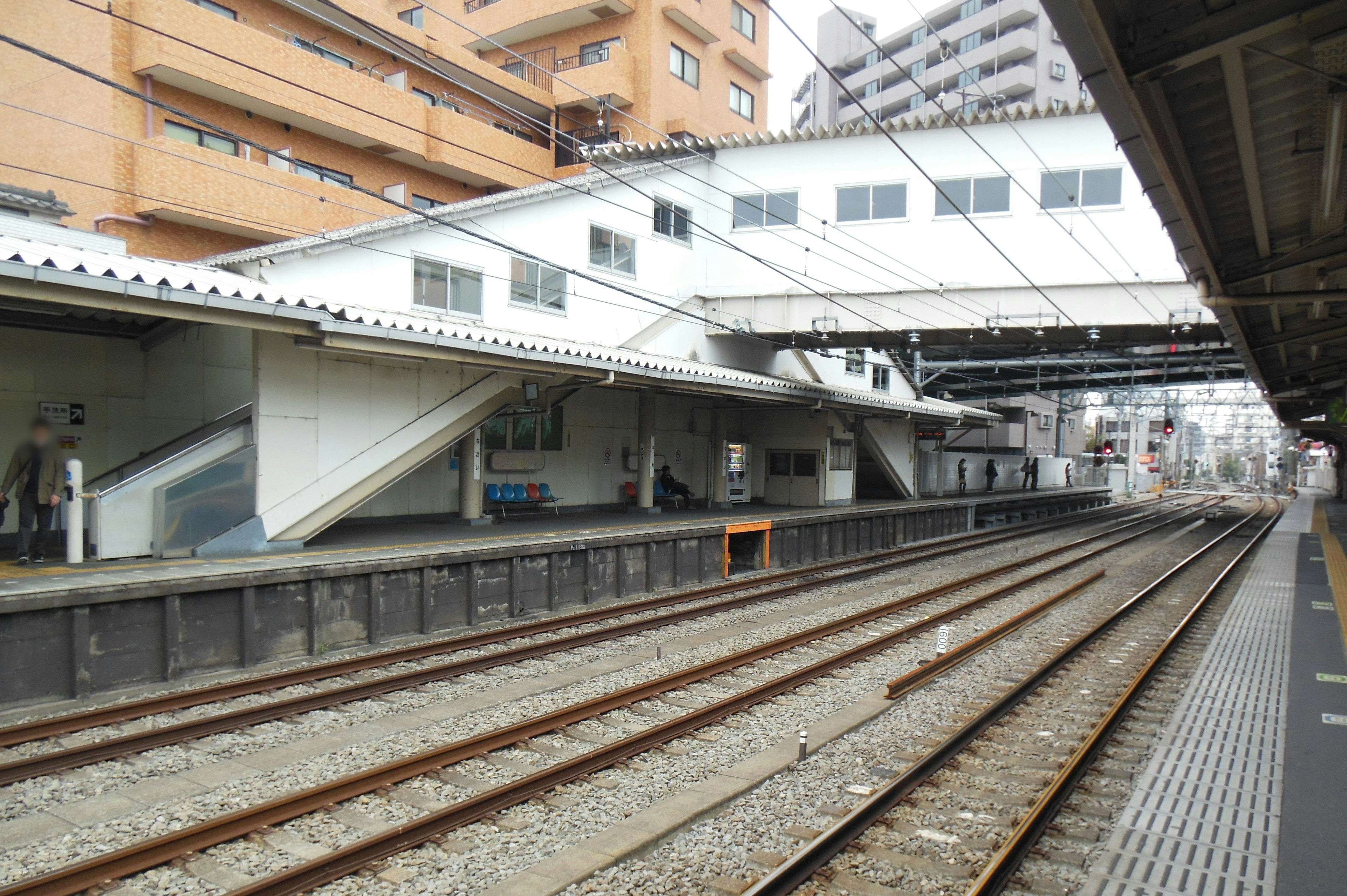 View of a train station platform and railway tracks