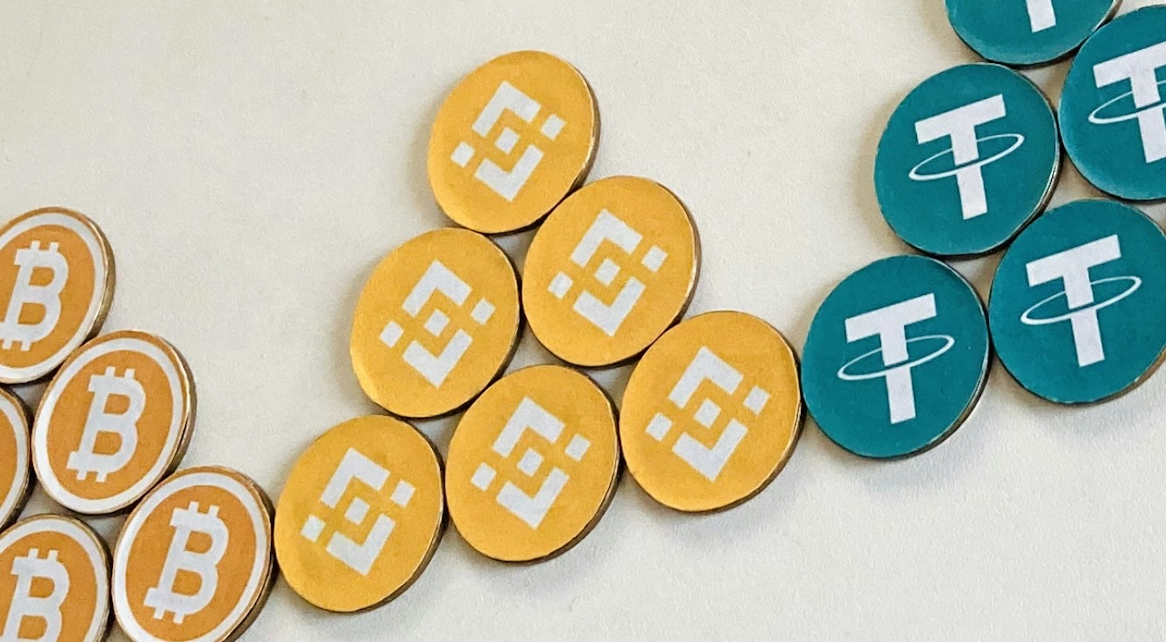 An arrangement of Bitcoin and Tether coins in various colors