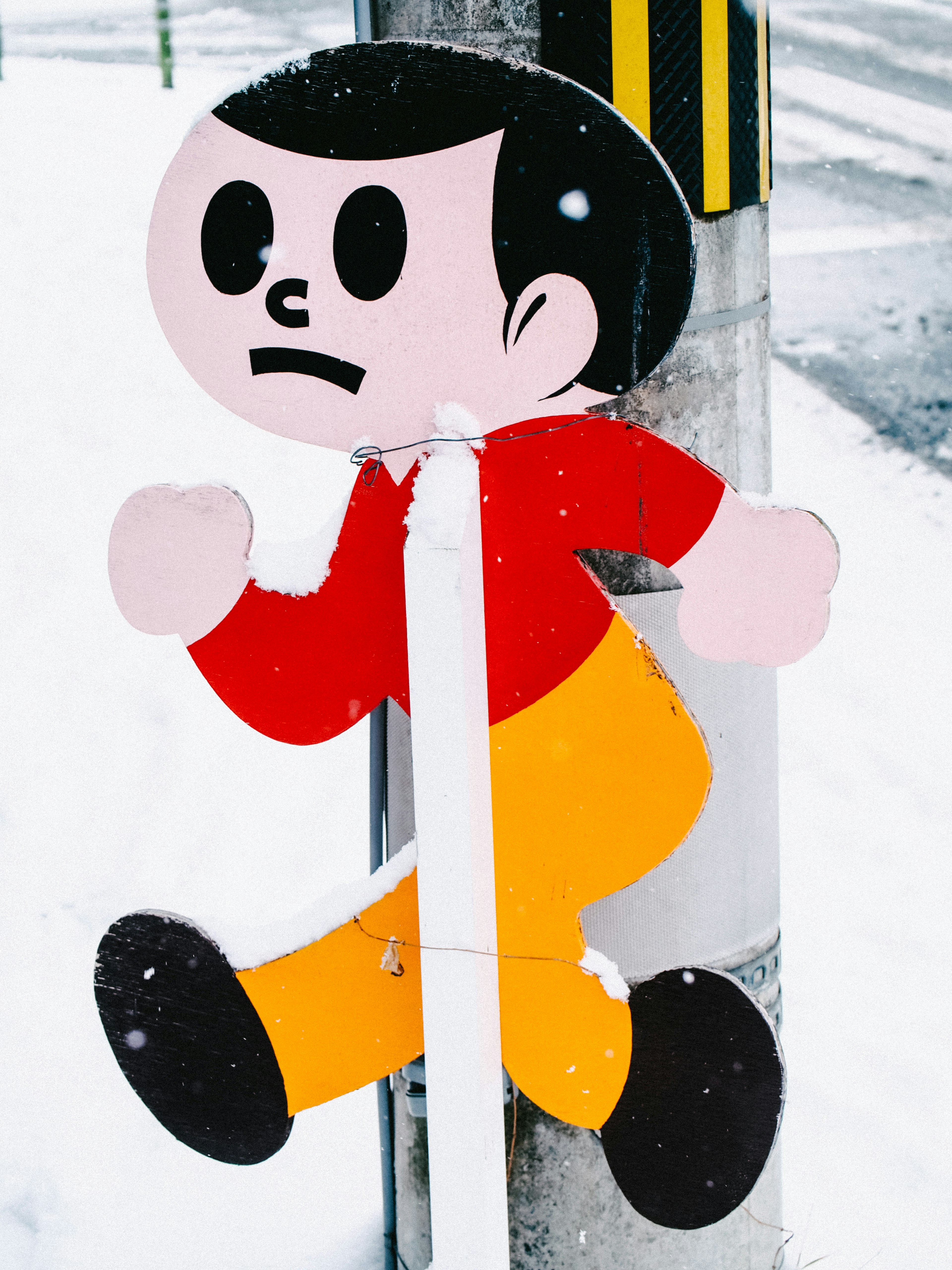 Traffic sign featuring a running cartoon character in snow