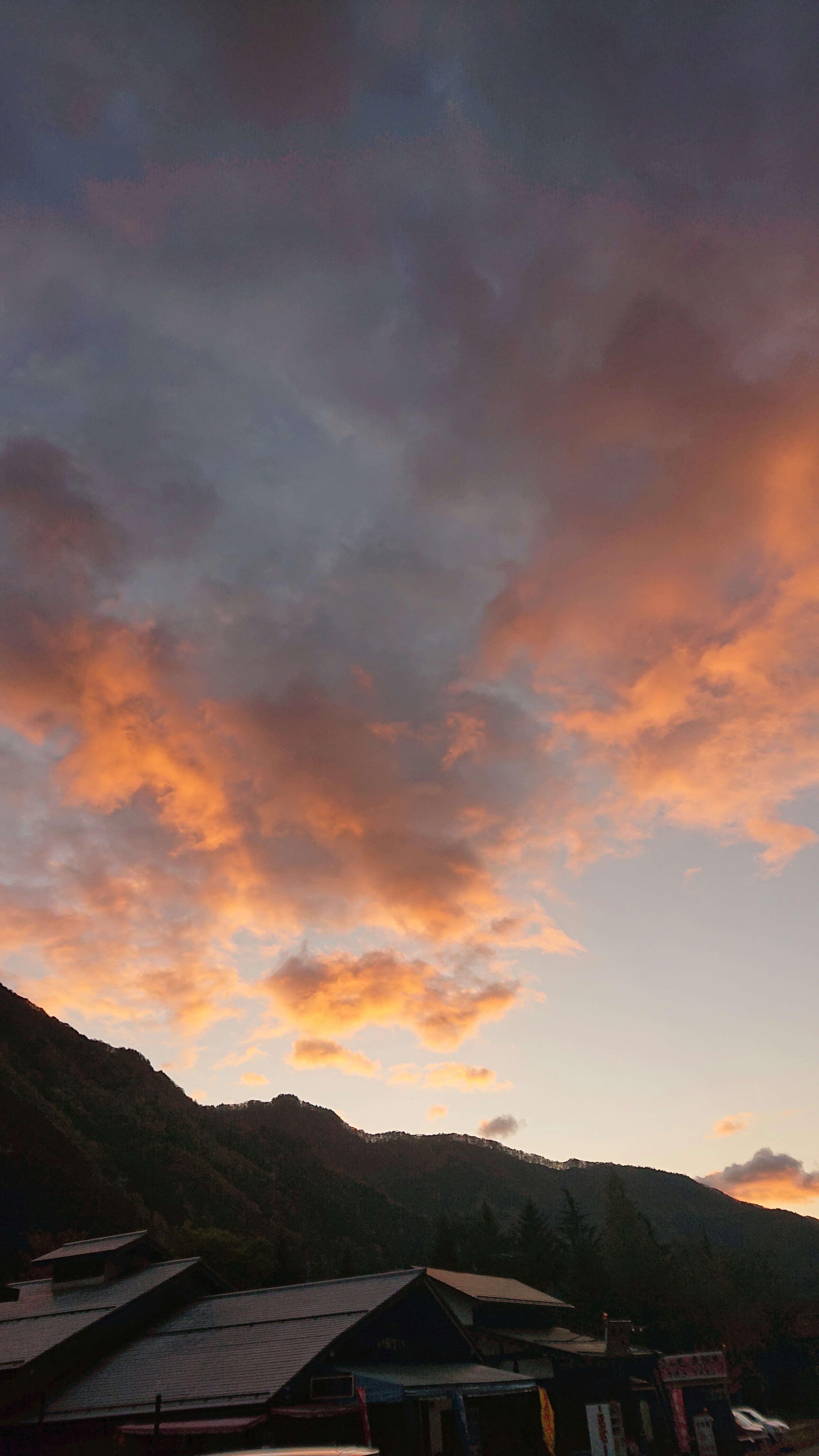 Vista panoramica di un cielo al tramonto con nuvole arancioni e viola