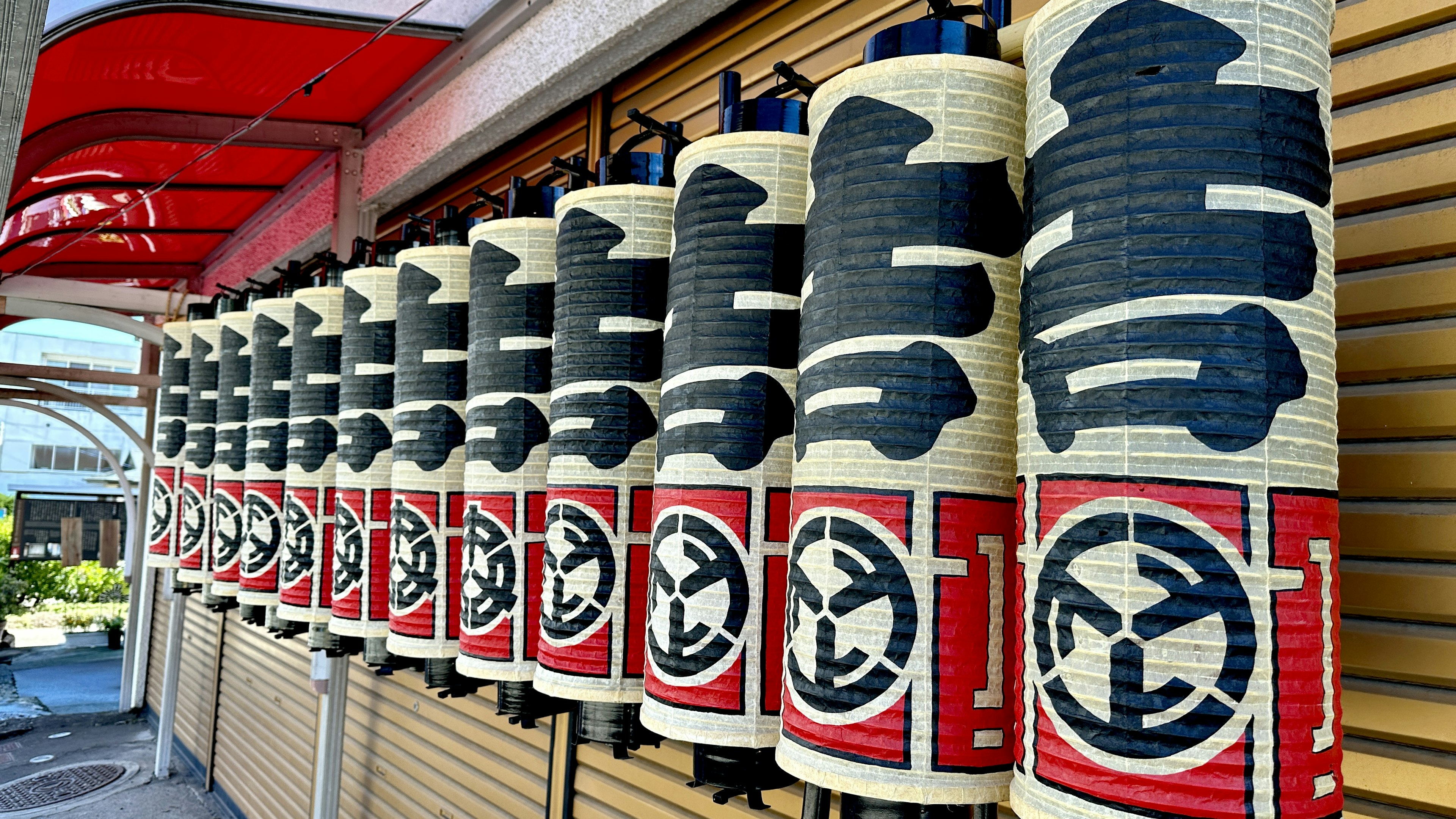 A row of traditional Japanese lanterns with unique designs