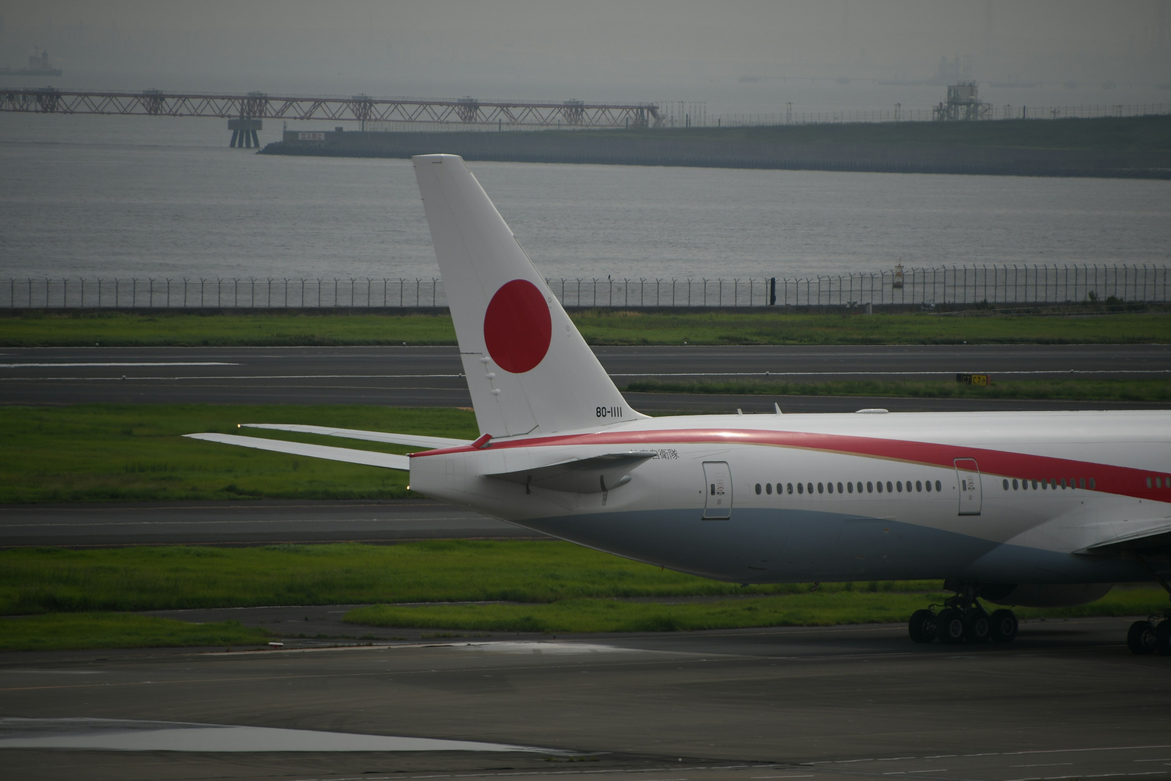 Tail of a Japanese airline airplane featuring a red circle design