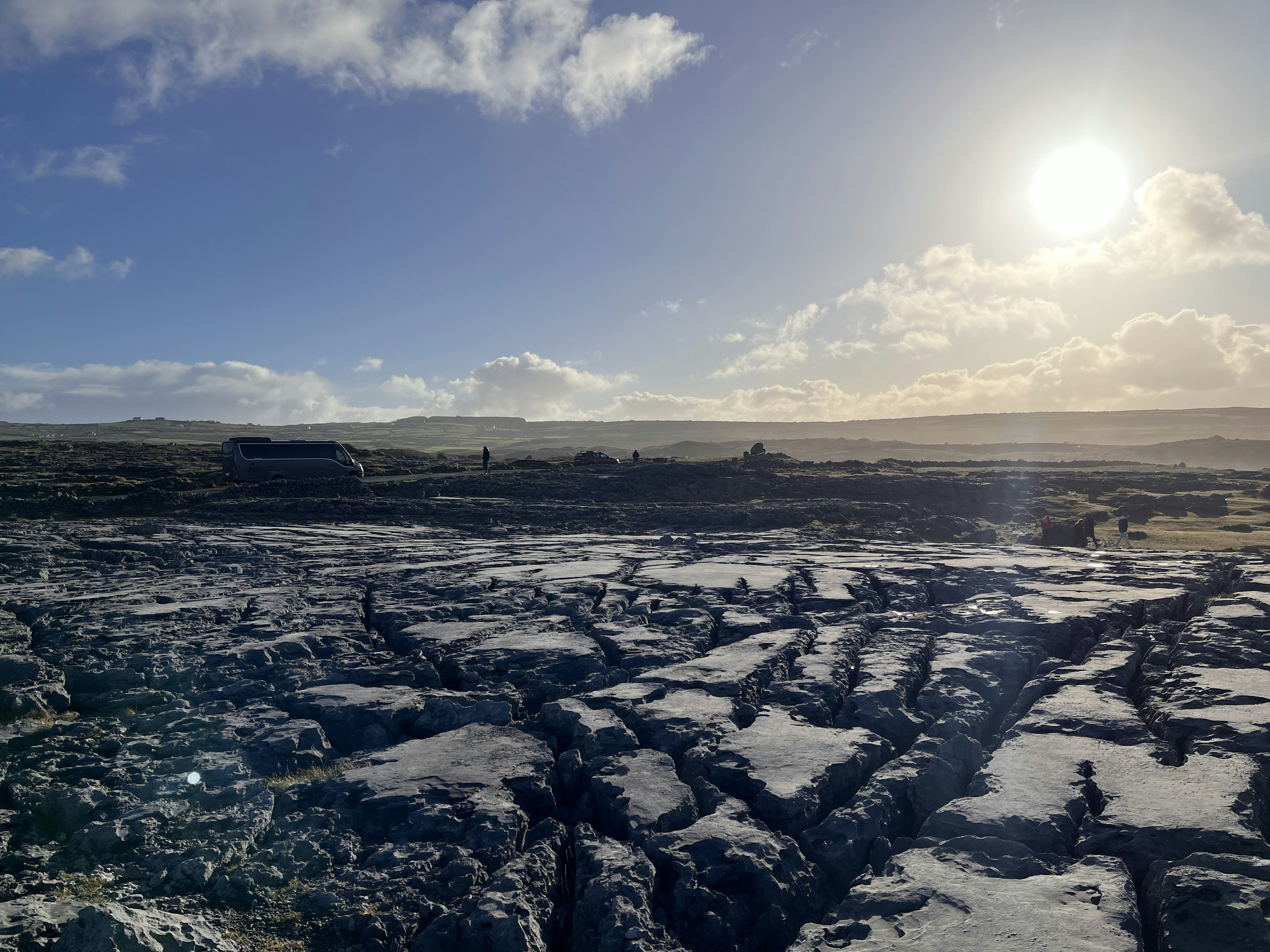 Wide rocky landscape with a bright sun in the sky