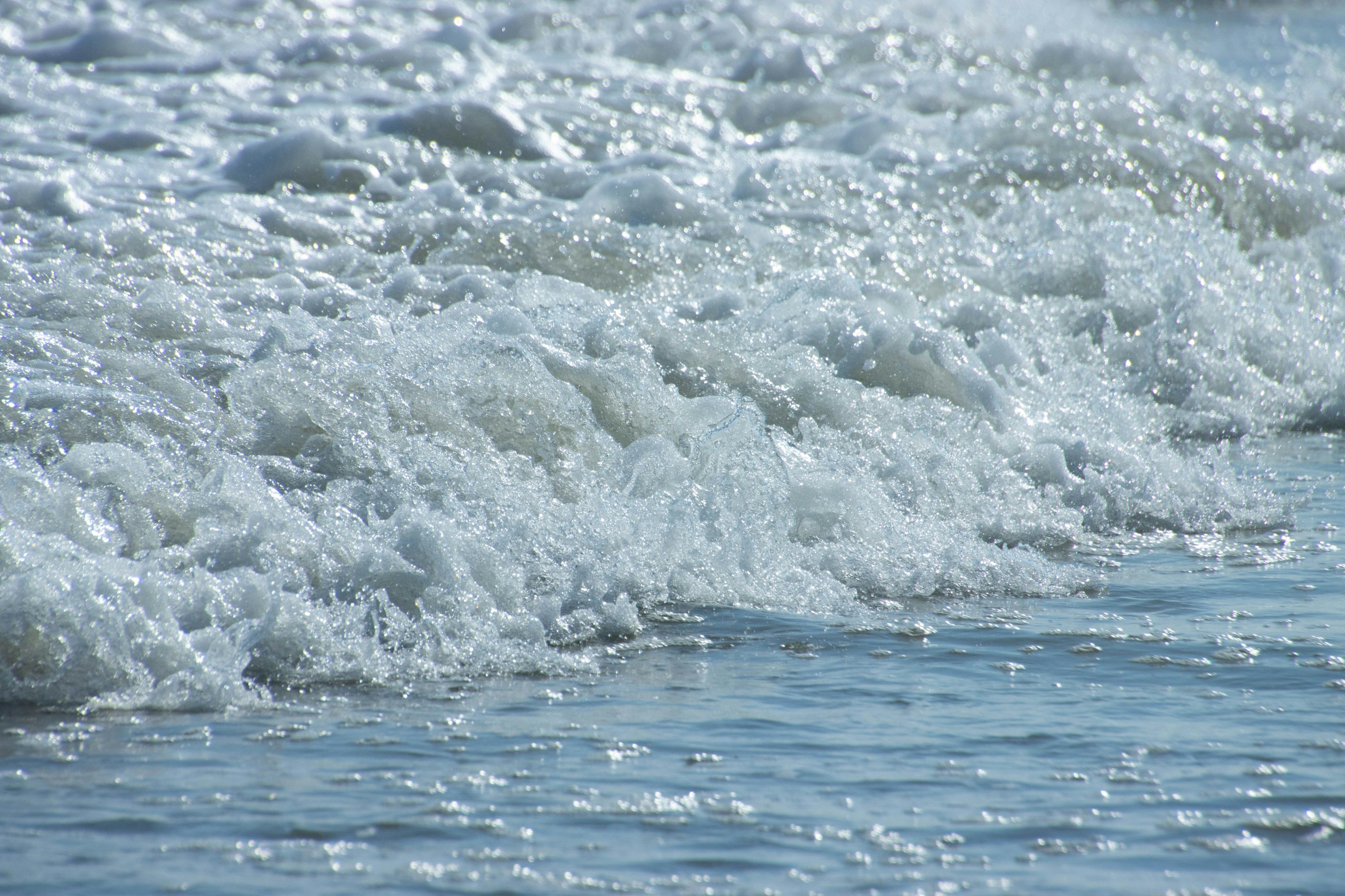 Close-up of ocean waves with foamy white surf