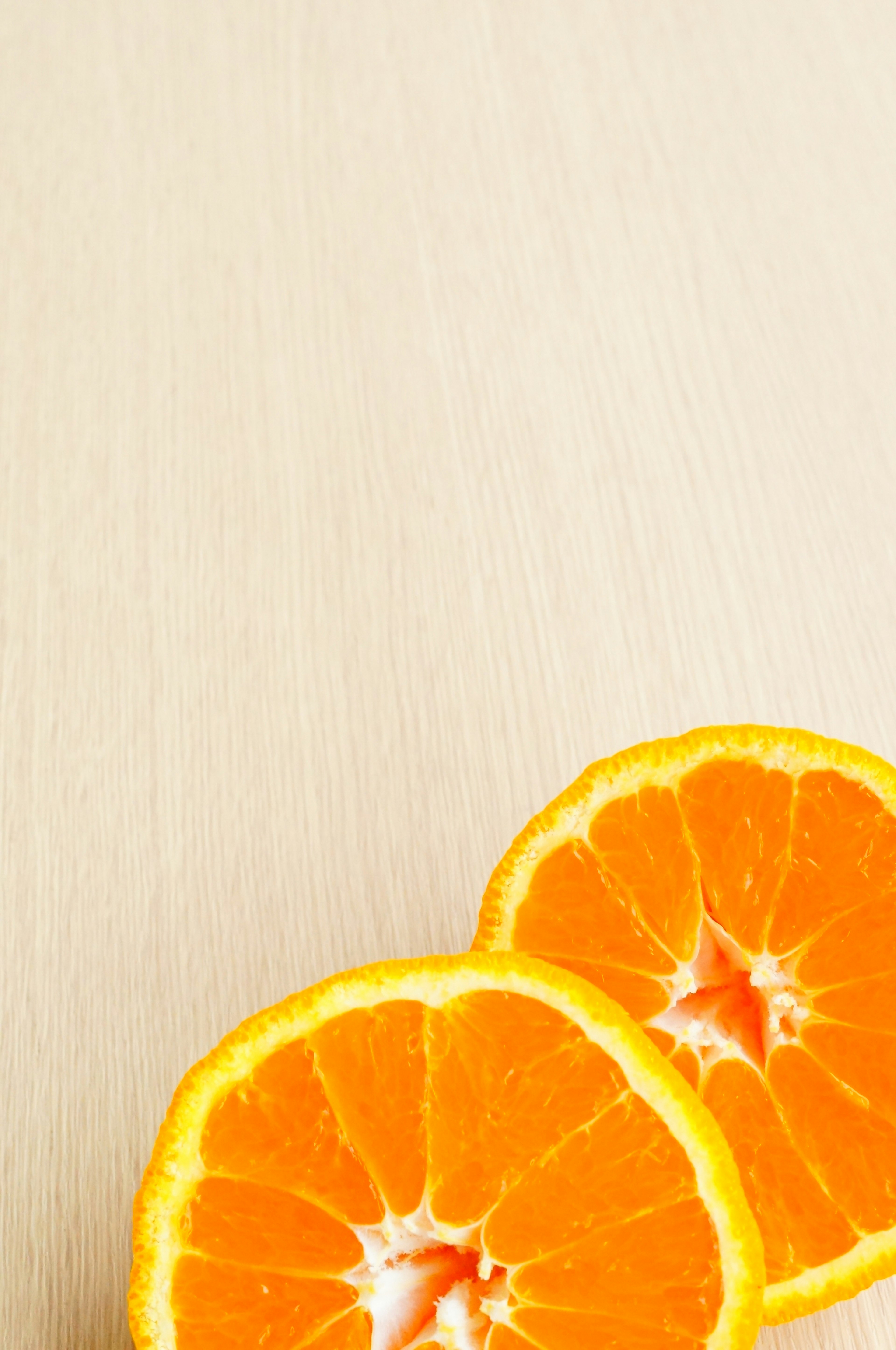 Sliced oranges on a wooden table surface