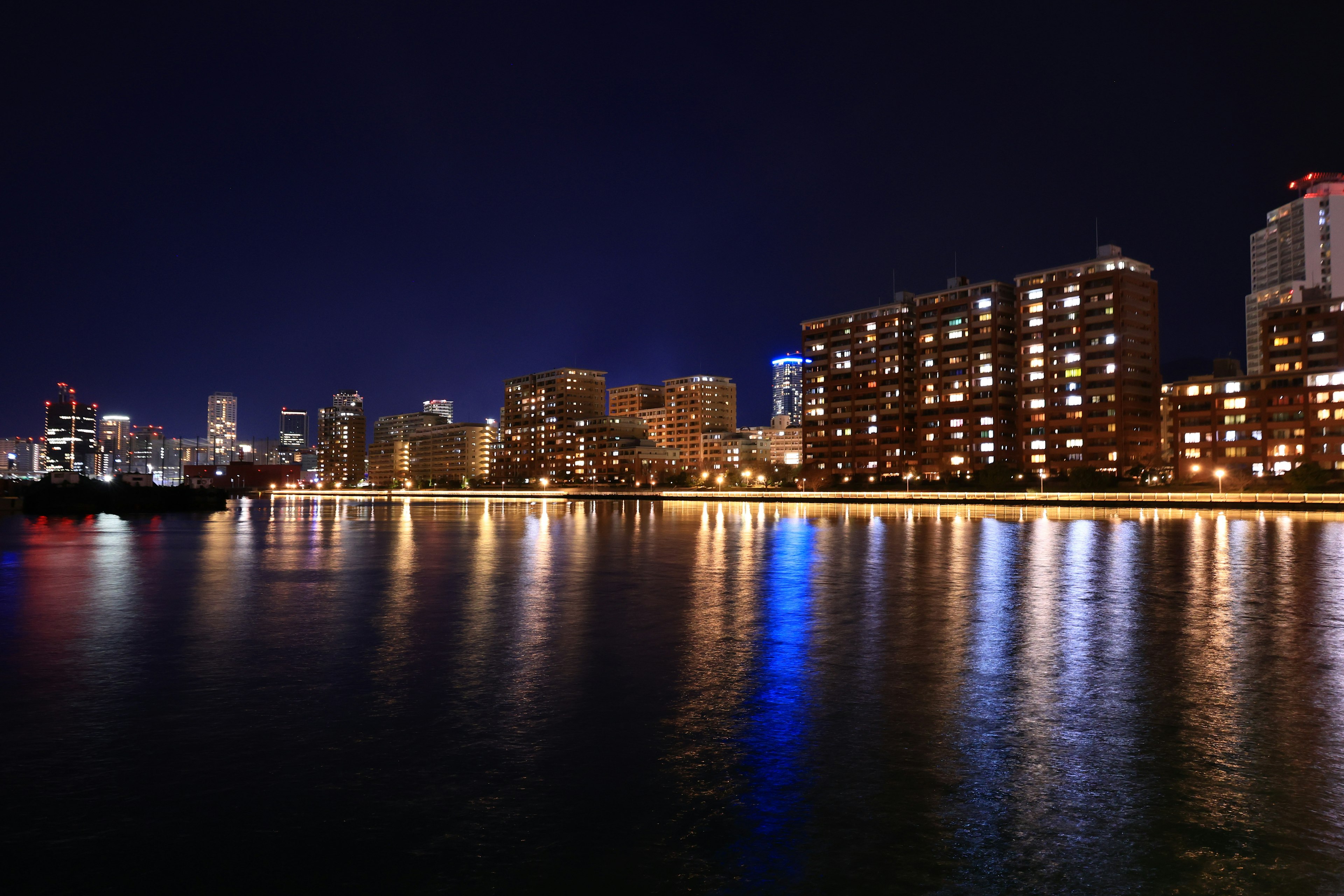 Paisaje urbano nocturno con reflejos en el agua