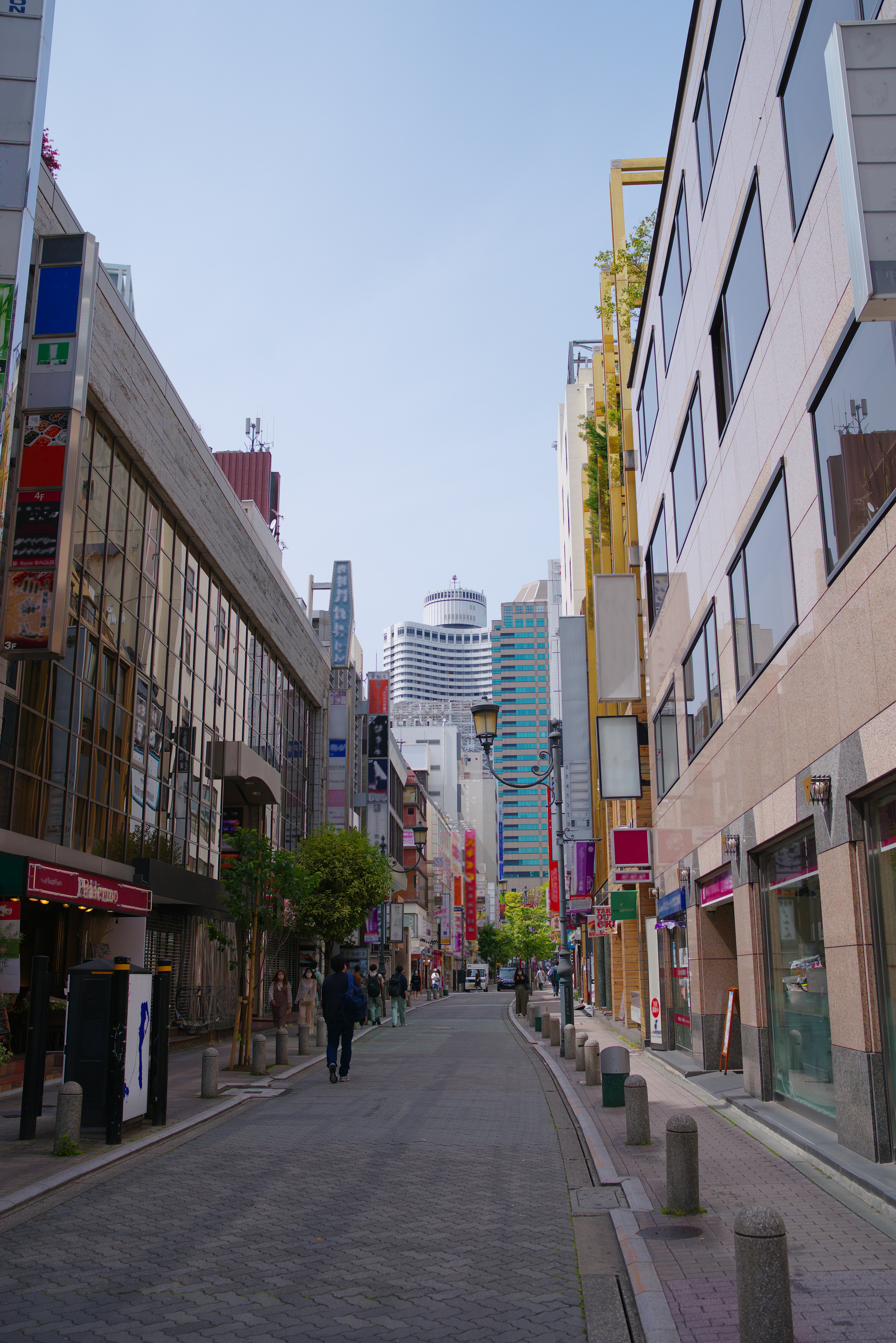 Modern buildings and colorful signs along a lively street