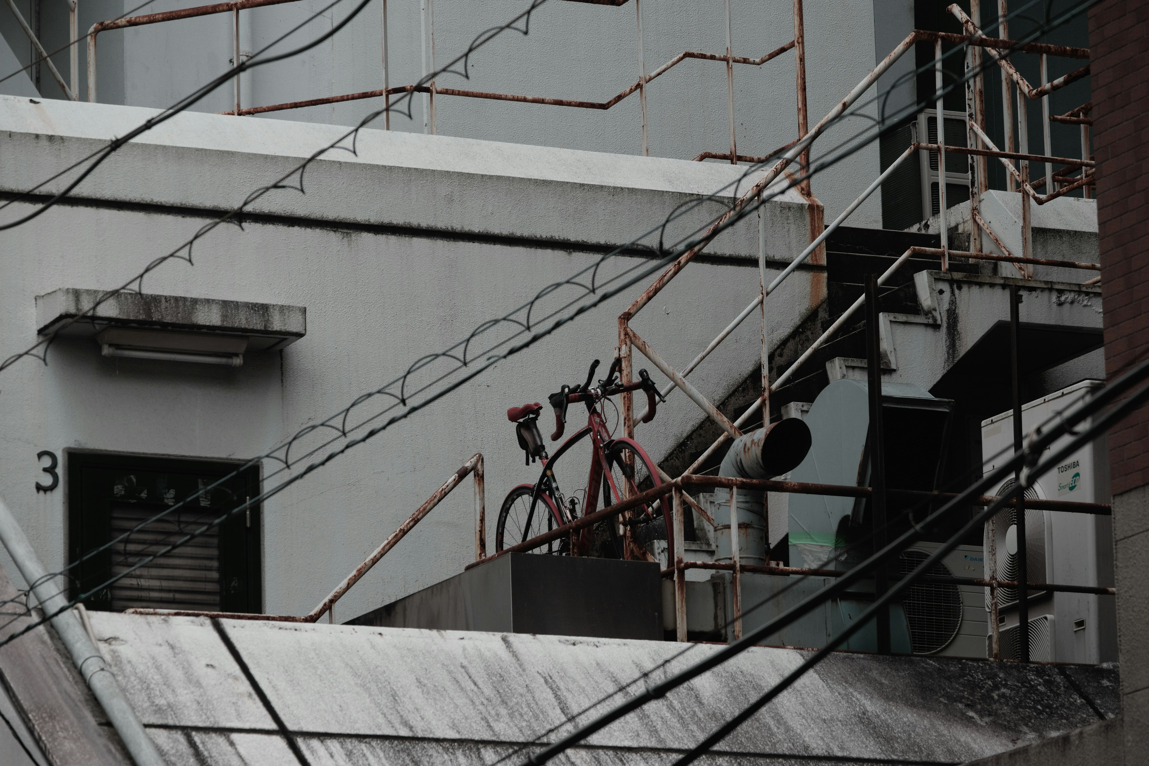 Bicicleta en un techo con líneas eléctricas cruzadas